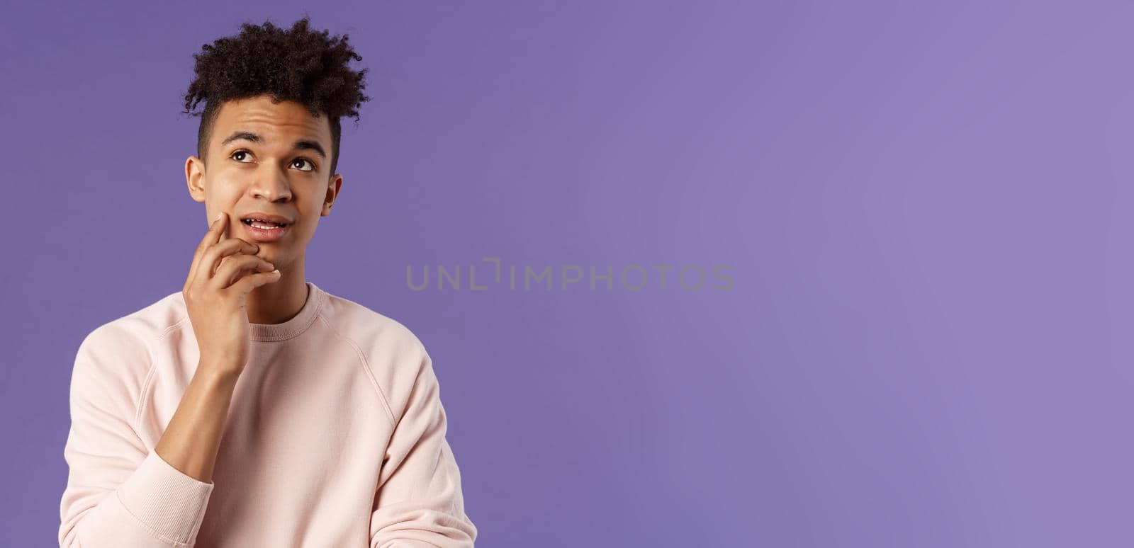 Waist-up portrait of thoughtful unsure young hispanic male student trying solve exercise, looking up thinking, pondering and calculating in mind, standing focused and indecisive purple background by Benzoix