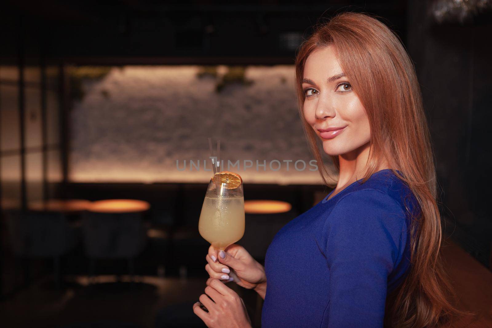 Gorgeous elegant woman enjoying cocktail at the bar by MAD_Production