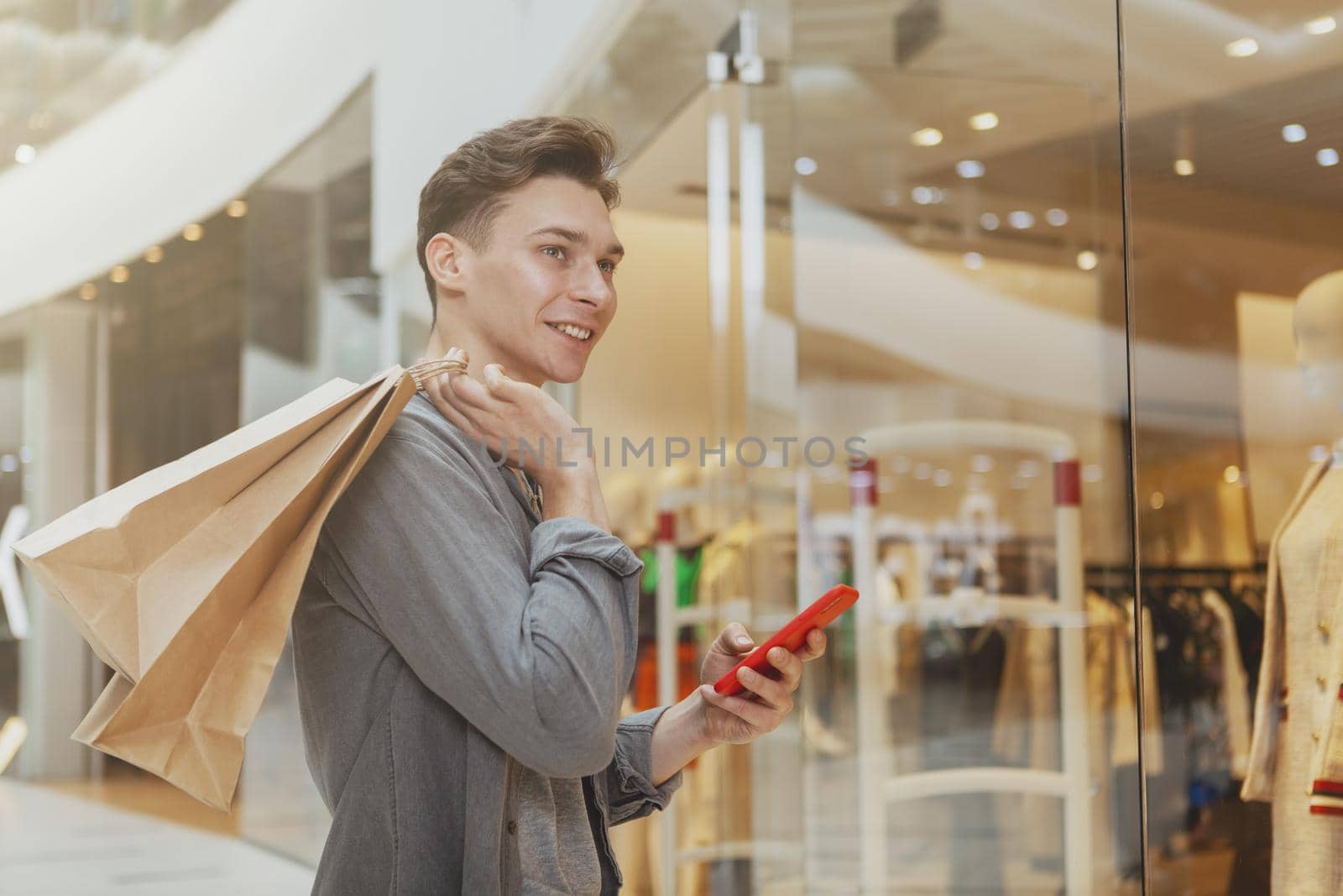 Handsome young man shopping at the mall by MAD_Production