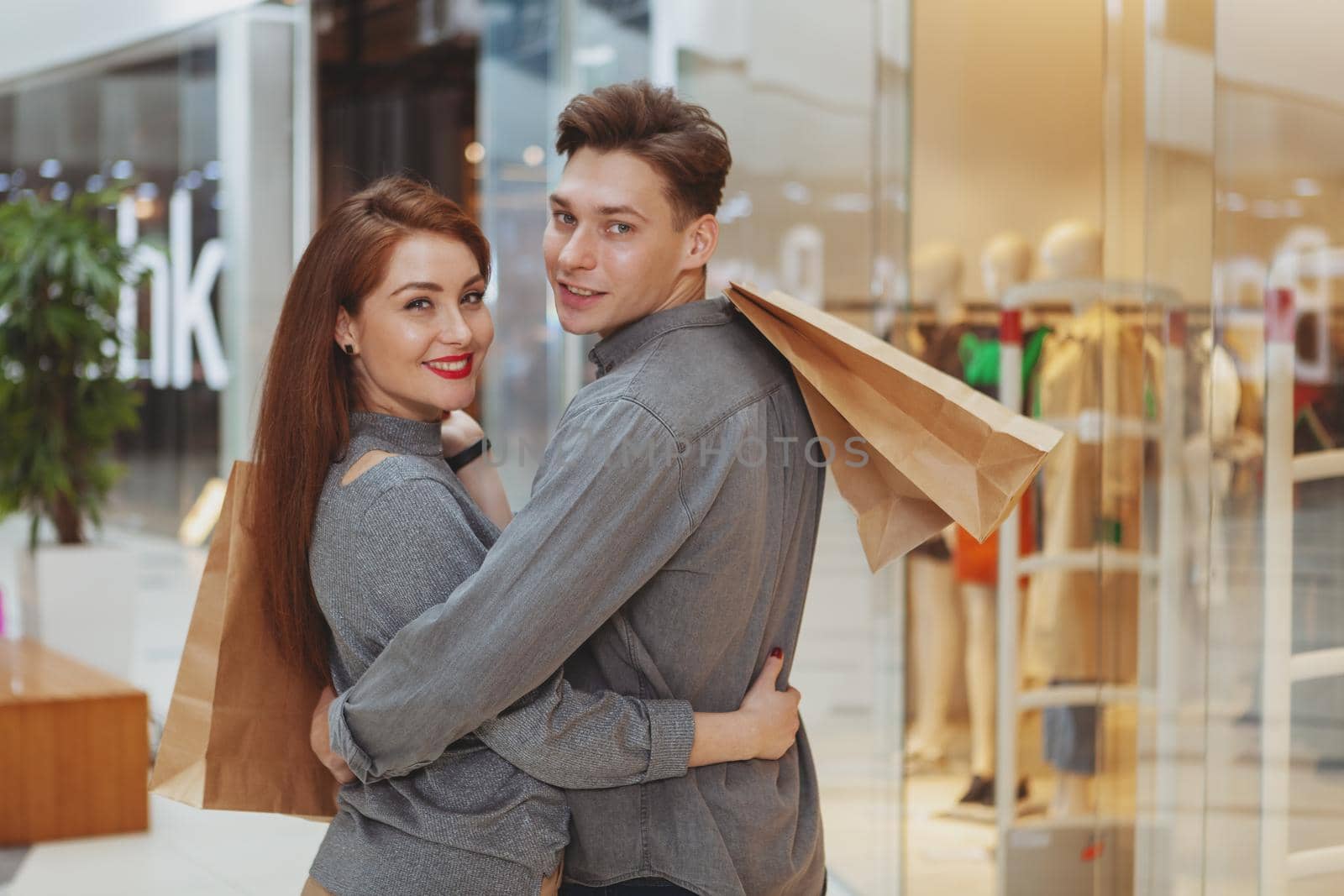 Lovely young couple shopping at the mall together by MAD_Production