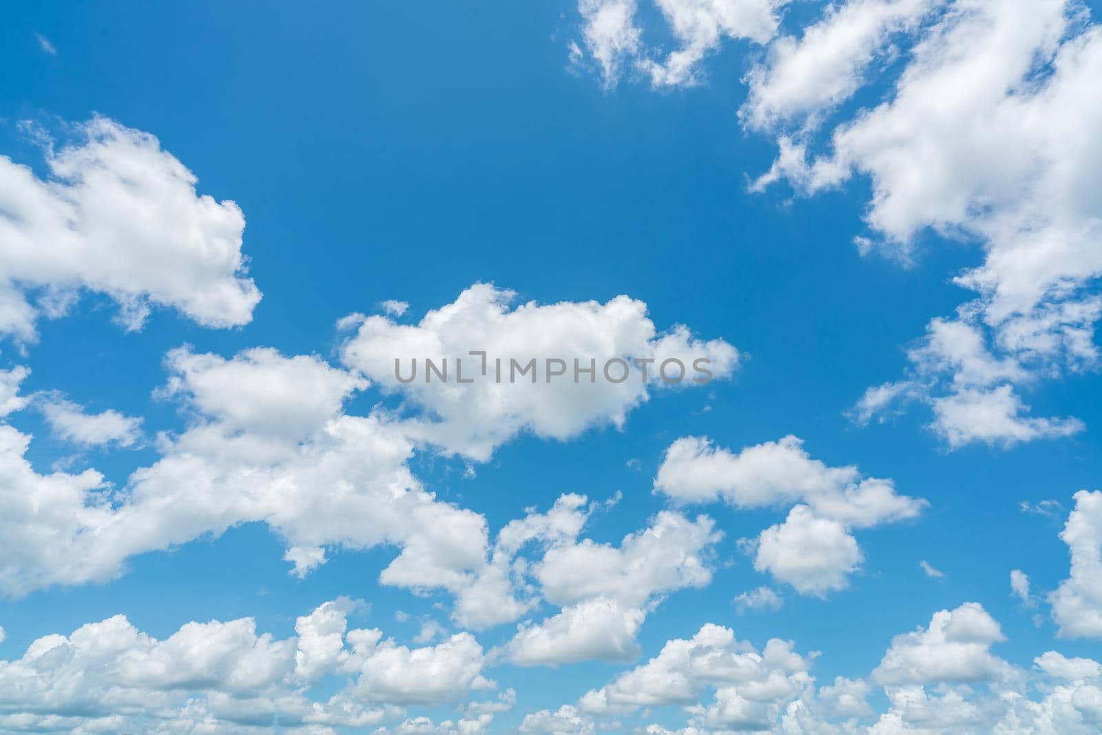 Beautiful blue sky and white cumulus clouds abstract background. Cloudscape background. Blue sky and fluffy white clouds on sunny day. Nice weather. Beauty cumulus cloudscape. Summer sky weather. by Fahroni