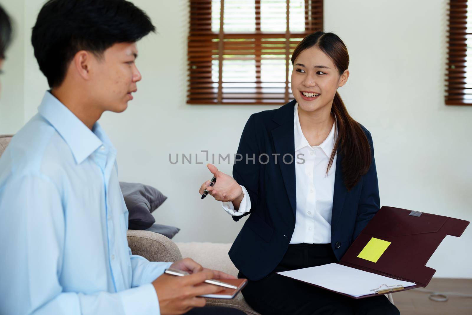 Couples consult with a representative to plan an insurance contract