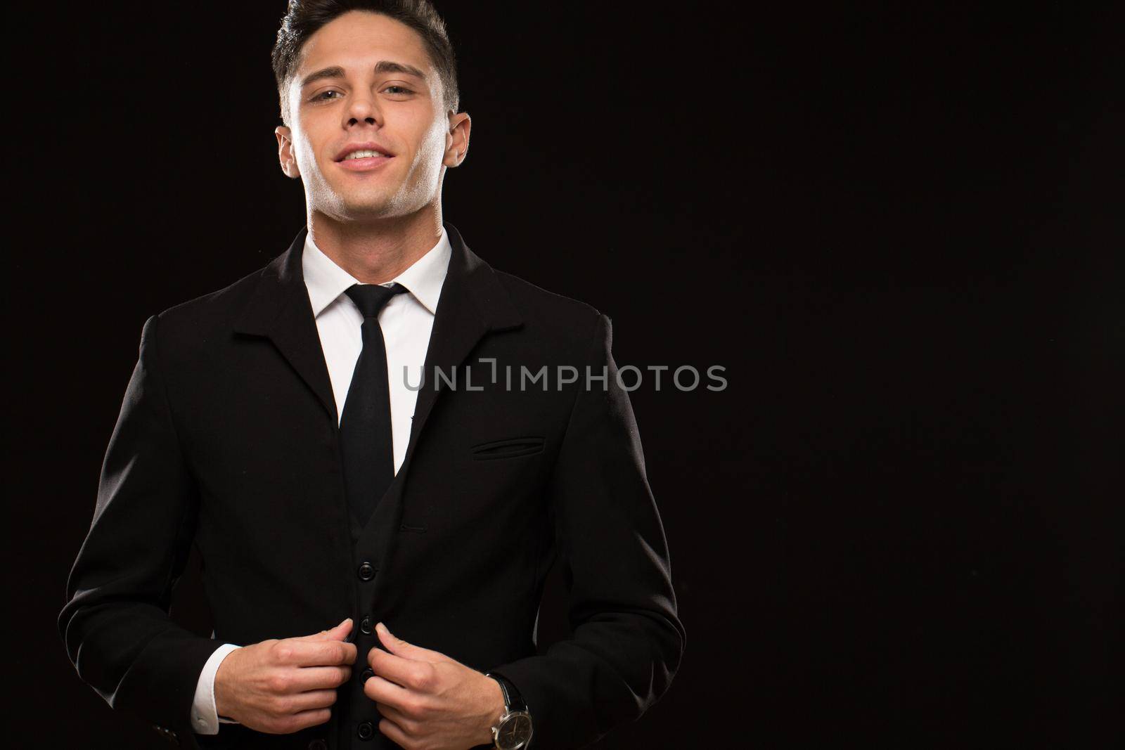 Portrait of a handsome young man wearing elegant black suit and tie posing confidently on black background copyspace masculinity businessman wealth sexy confident suited dressed up stylish