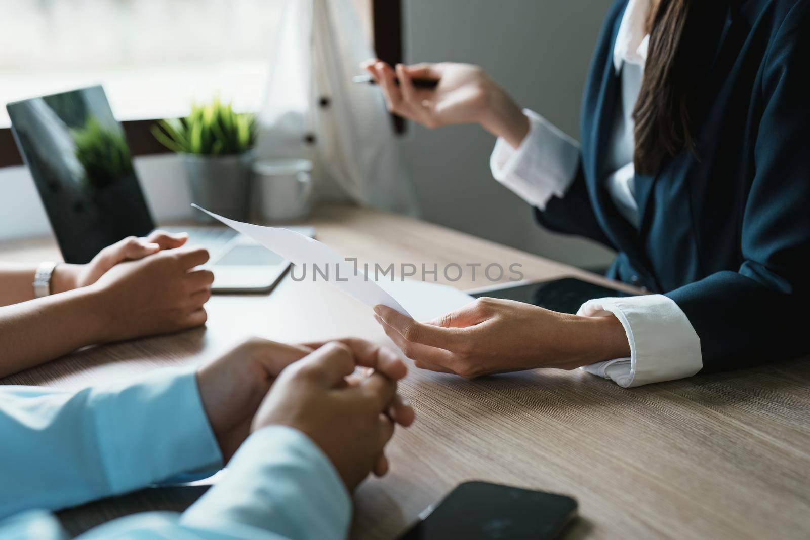 Couples consult with a representative to plan an insurance contract by Manastrong