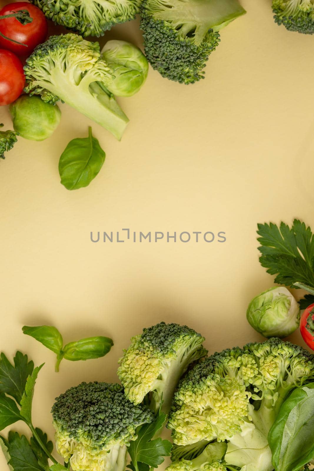 Vegetables food pattern made of broccoli, Brussels sprouts, tomatoes, herbs on light pastel background. Minimal flat lay design, nutrition, healthy eating, diets, vitamins. Top view, space for text