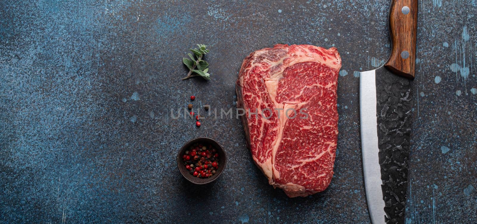Raw meat beef marbled prime cut steak Ribeye on rustic concrete kitchen table by its_al_dente
