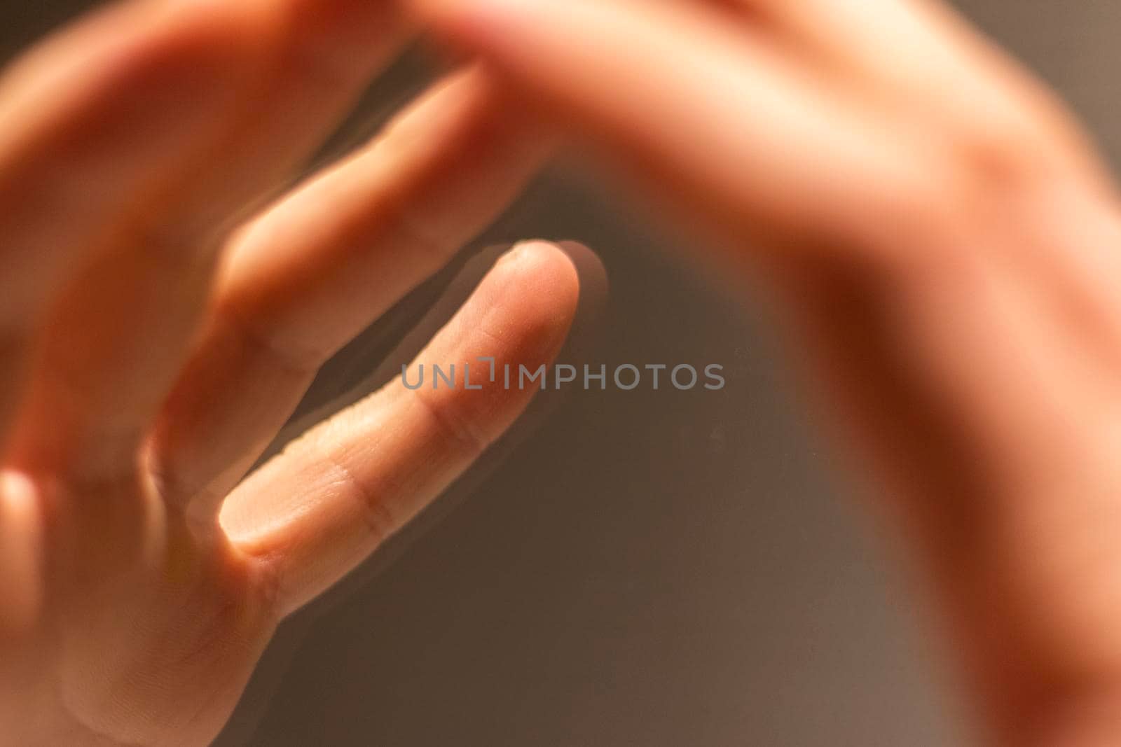 Close up shot of a hand's reflection in the mirror. Concept by pazemin