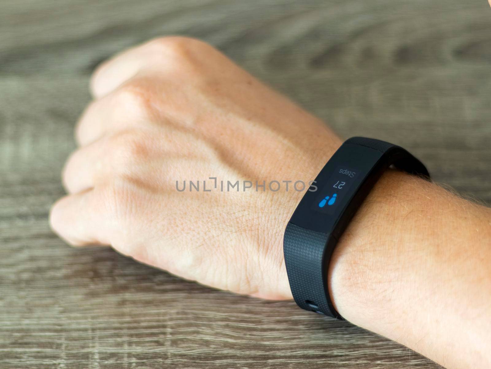 Close up shot of a man setting up a fitness wristband.