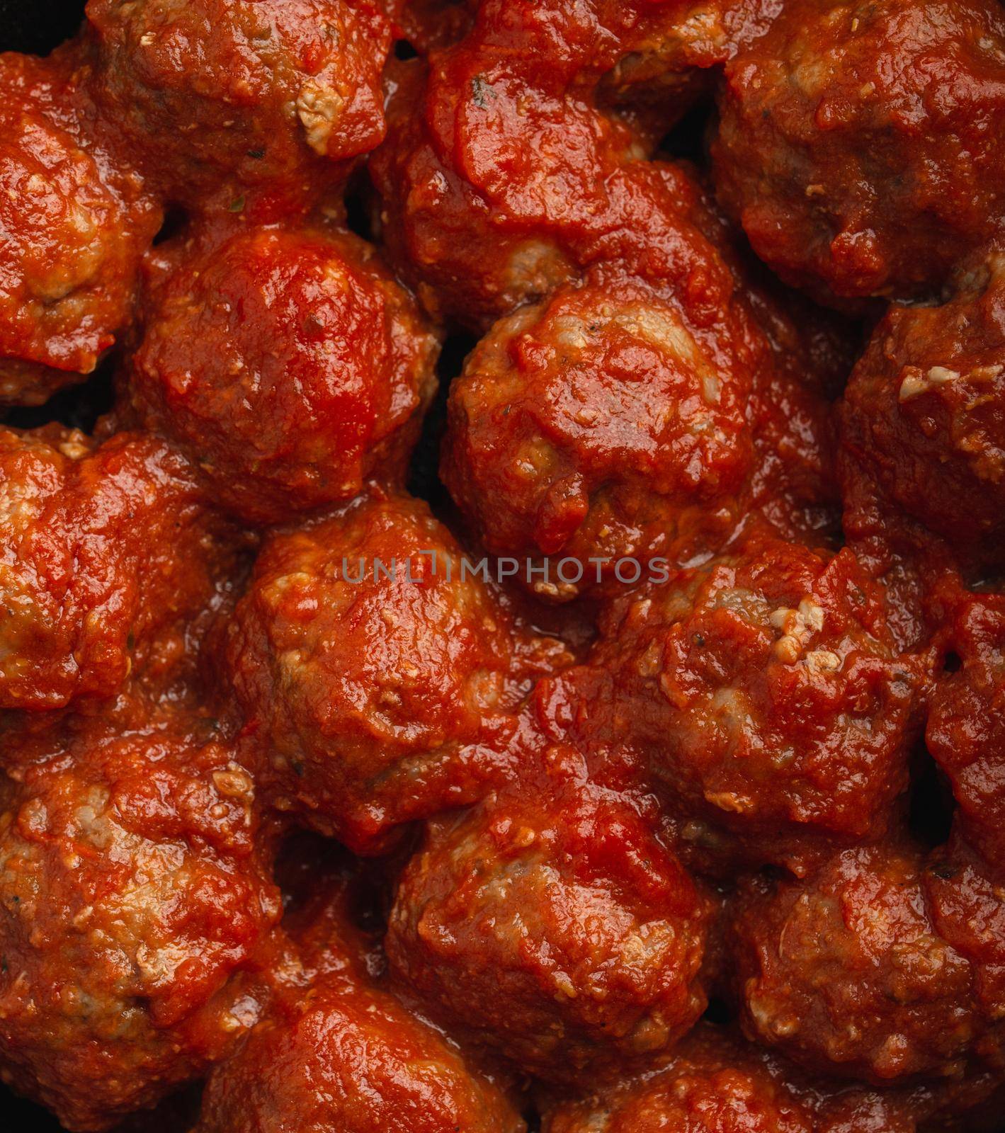 Close-up of delicious meatballs with tomato sauce, from above. Tasty homemade meatballs concept, food pattern background