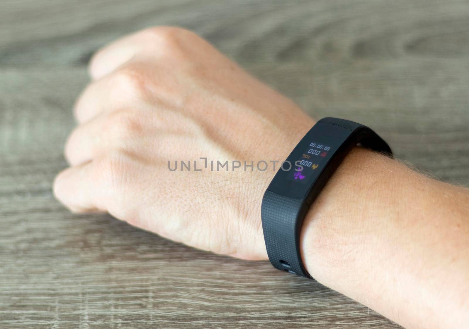 Close up shot of a man setting up a fitness wristband.