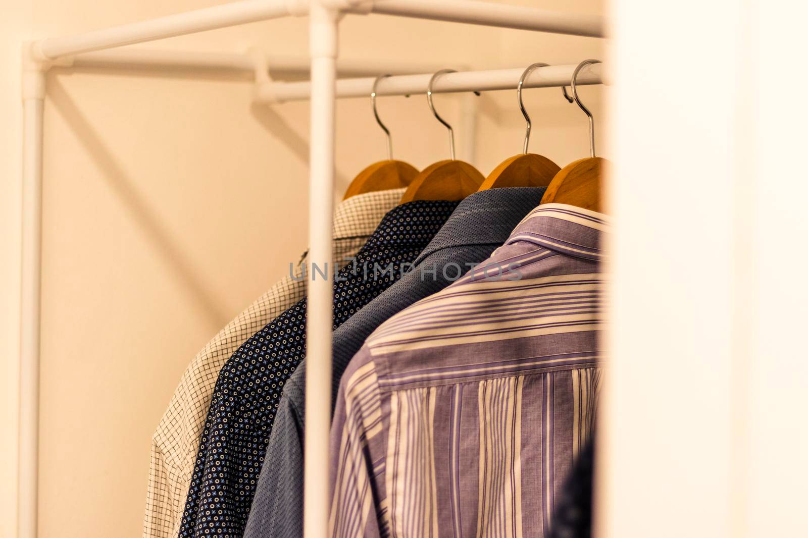 Close up shot of the shirts hanging on the rack. Clothing by pazemin