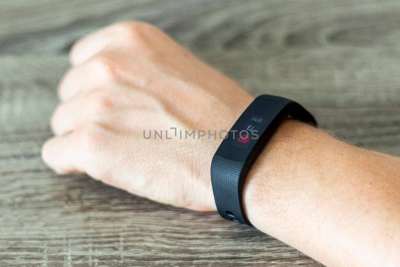 Close up shot of a man setting up a fitness wristband.