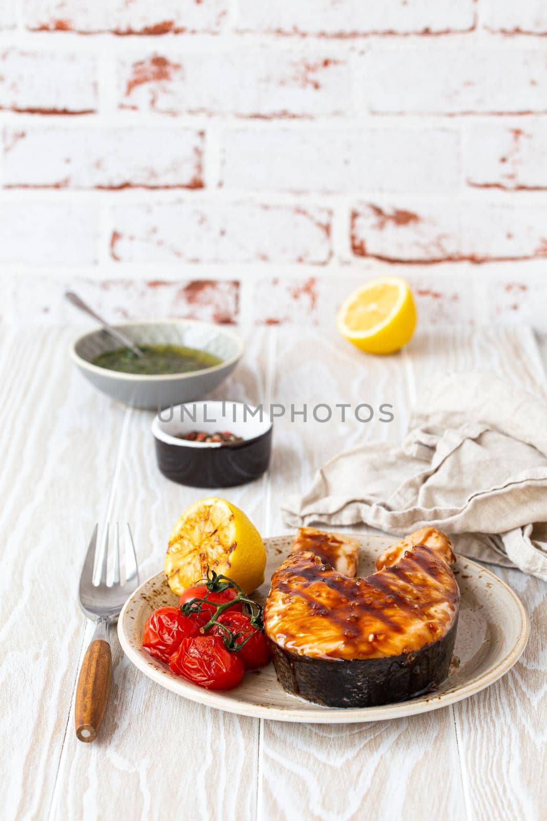 Grilled salmon steak on white wooden background by its_al_dente