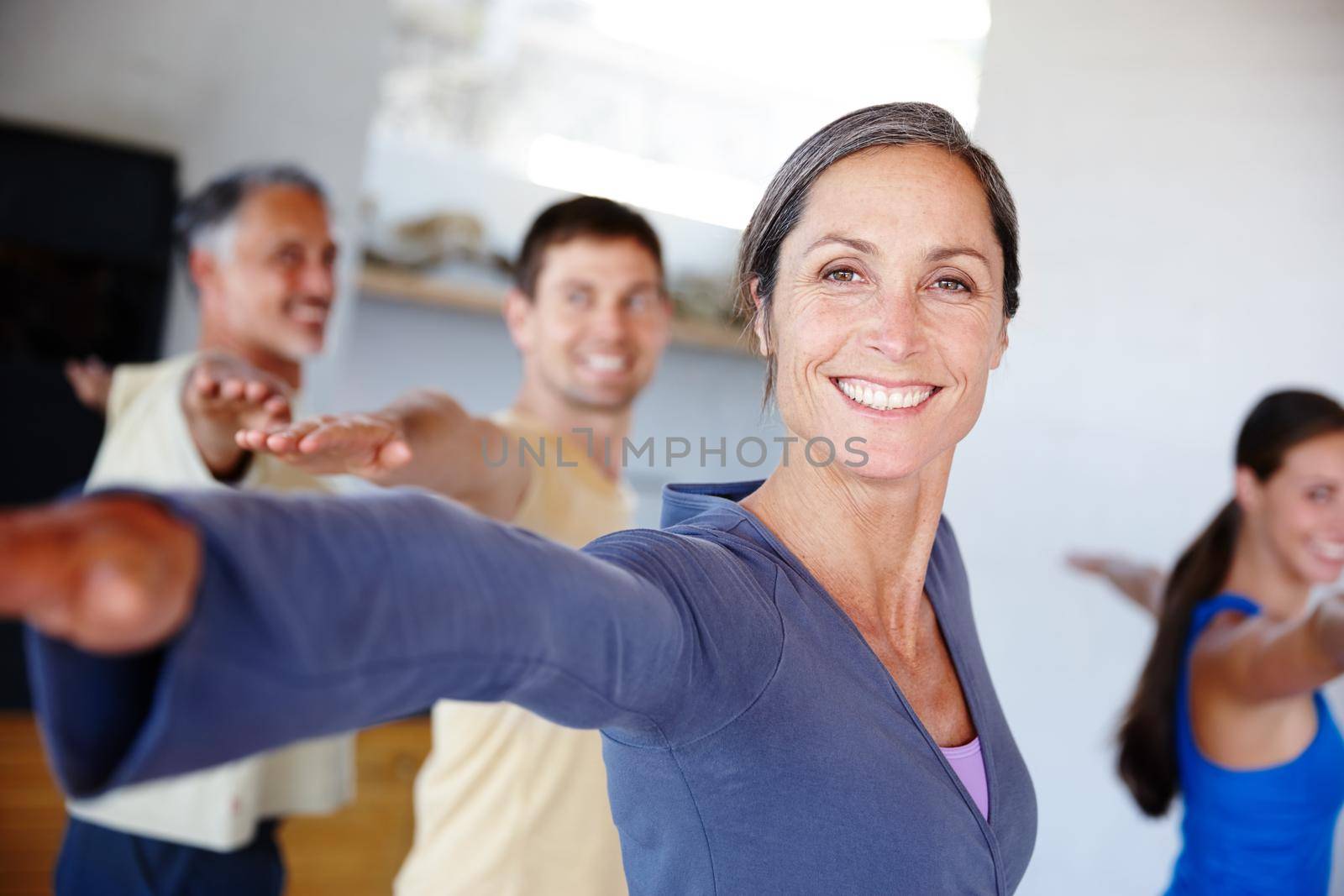 Health makes her happy. A group of people taking a class together at gym