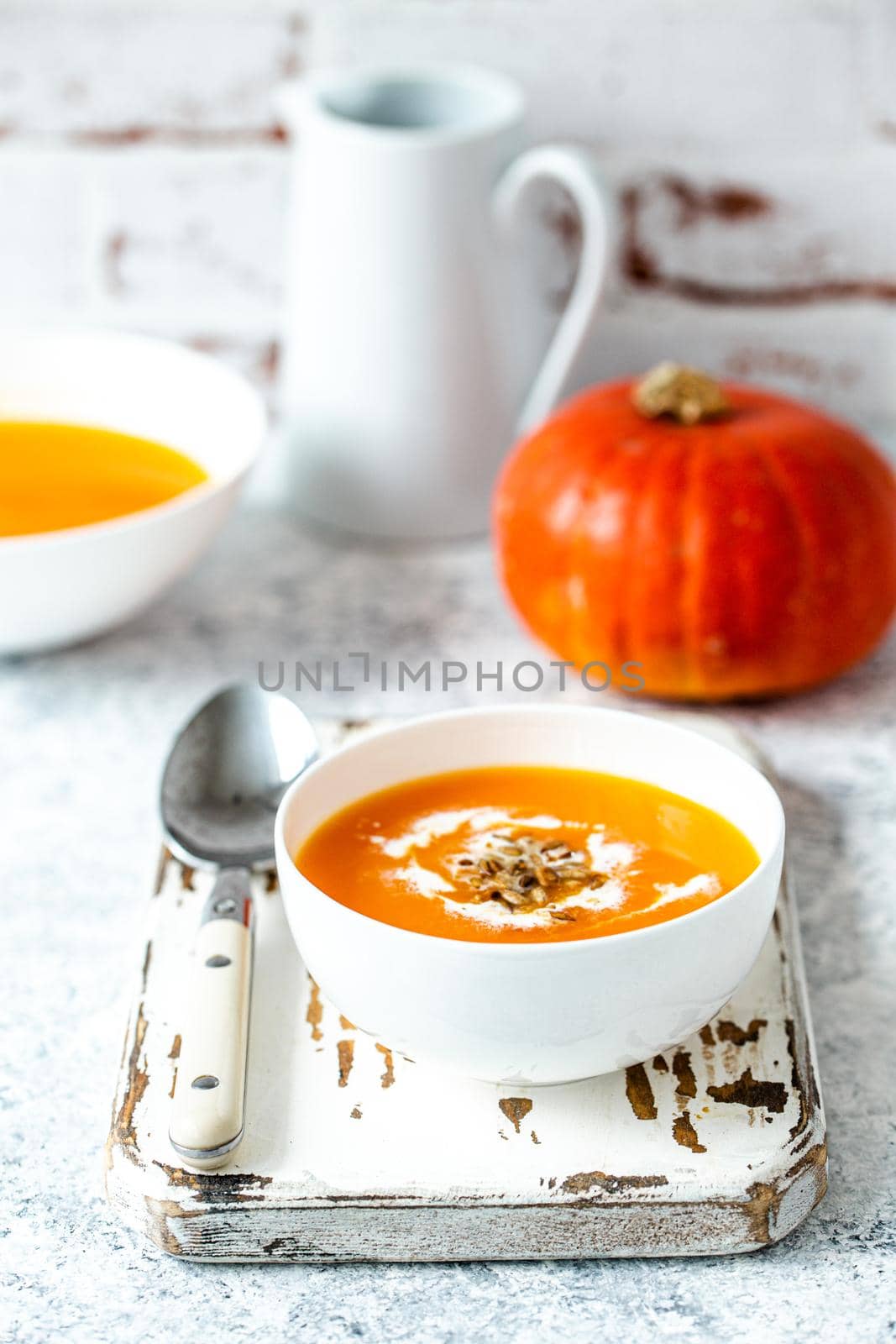 Pumpkin cream soup in white bowl by its_al_dente