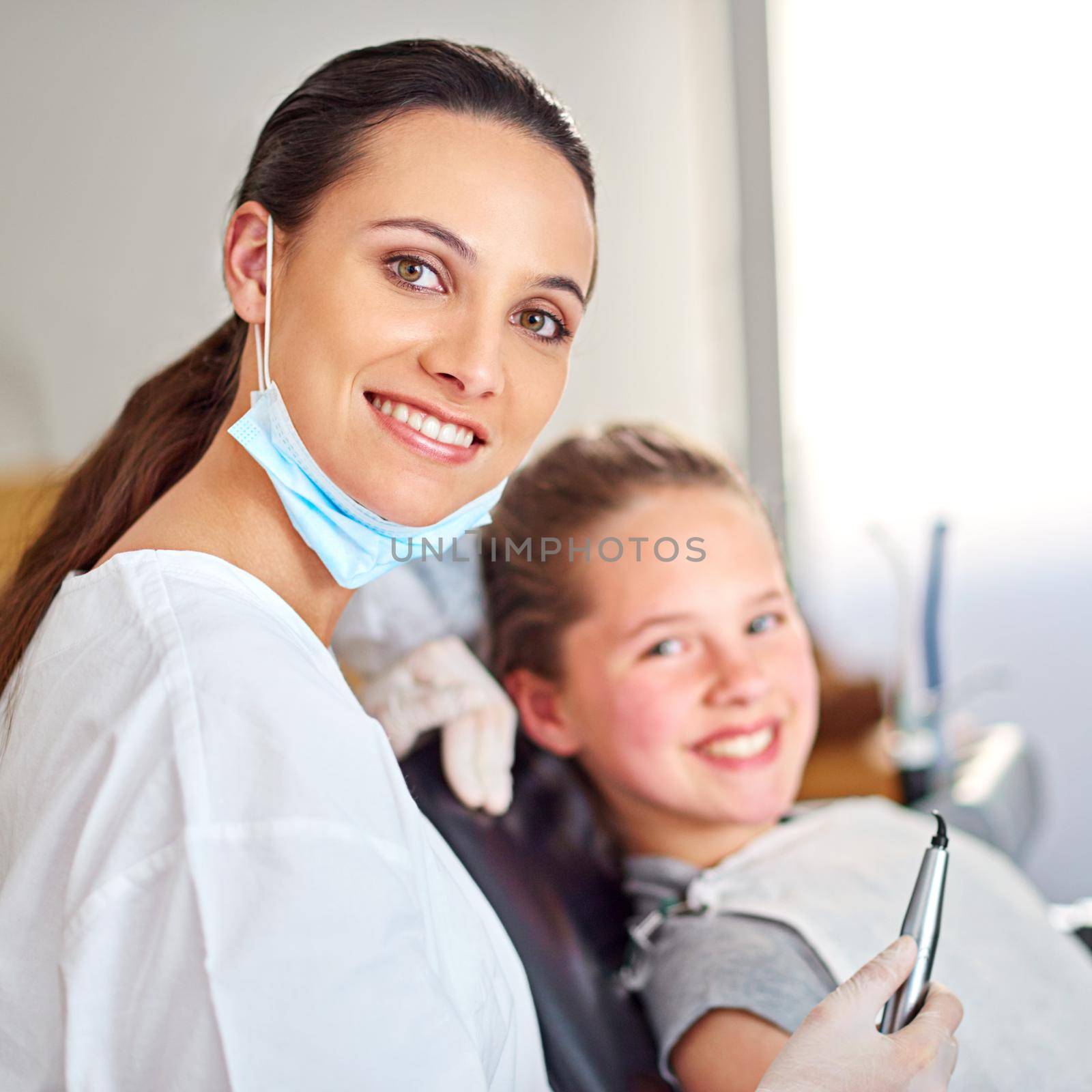 She takes good care of her young patients. Portrait of an attractive female dentist and her child patient. by YuriArcurs