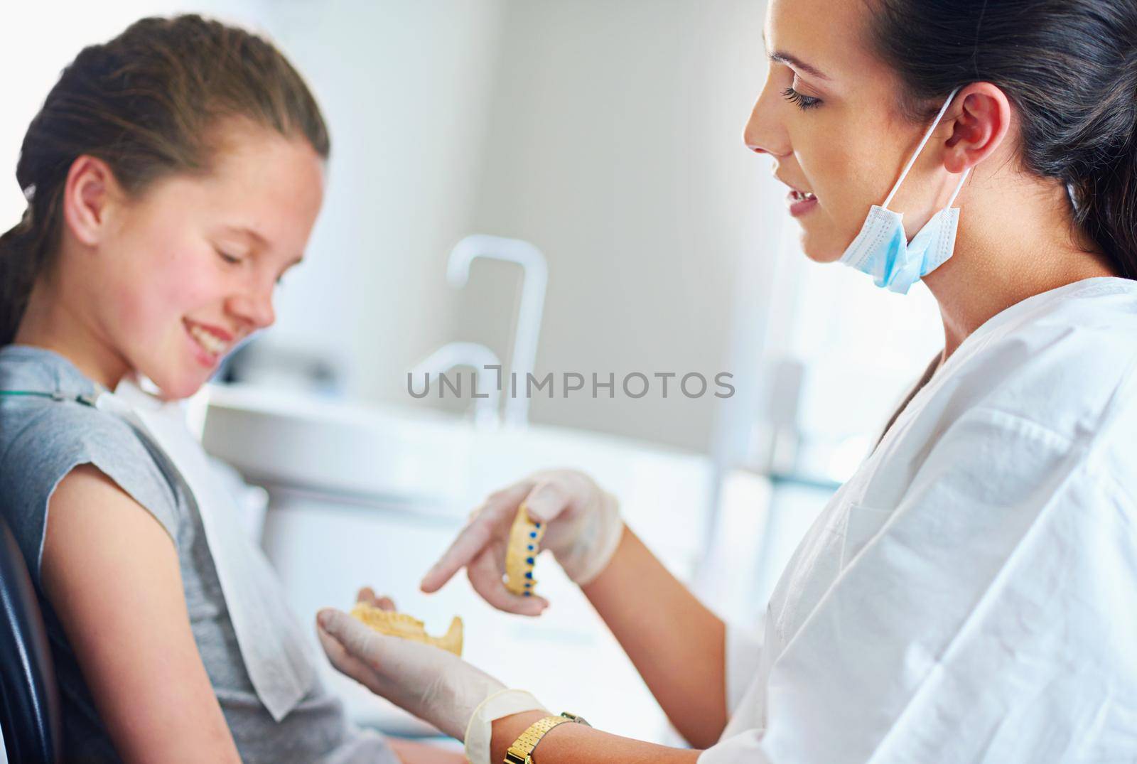 Oral hygiene can never be taught too early. a female dentist and child in a dentist office