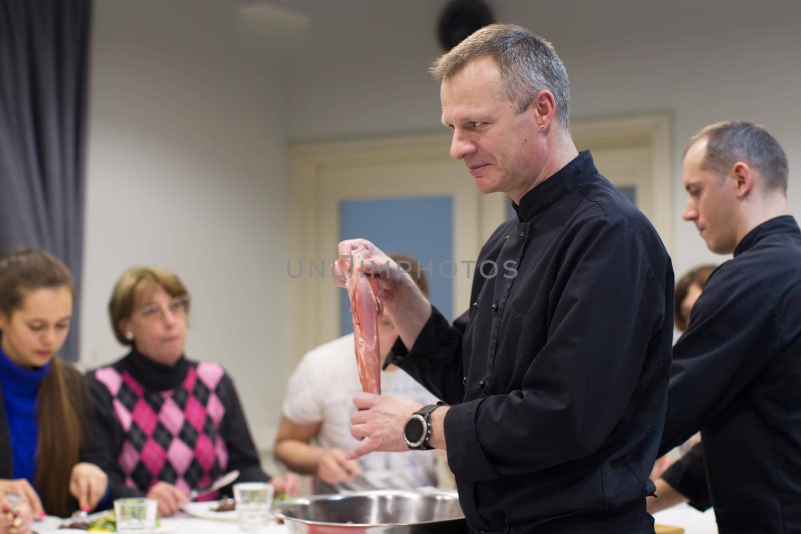 The cook teaches you how to cook food. Master class cooking. Chef looks at food.Teach me how to cook meat