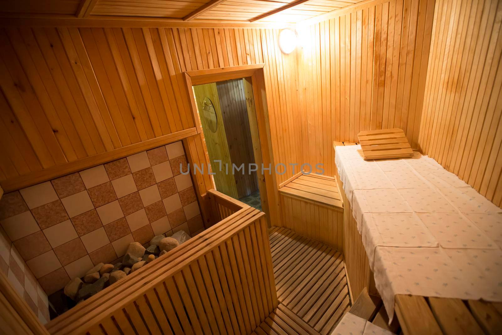 Interior of a wooden sauna with sun lounger