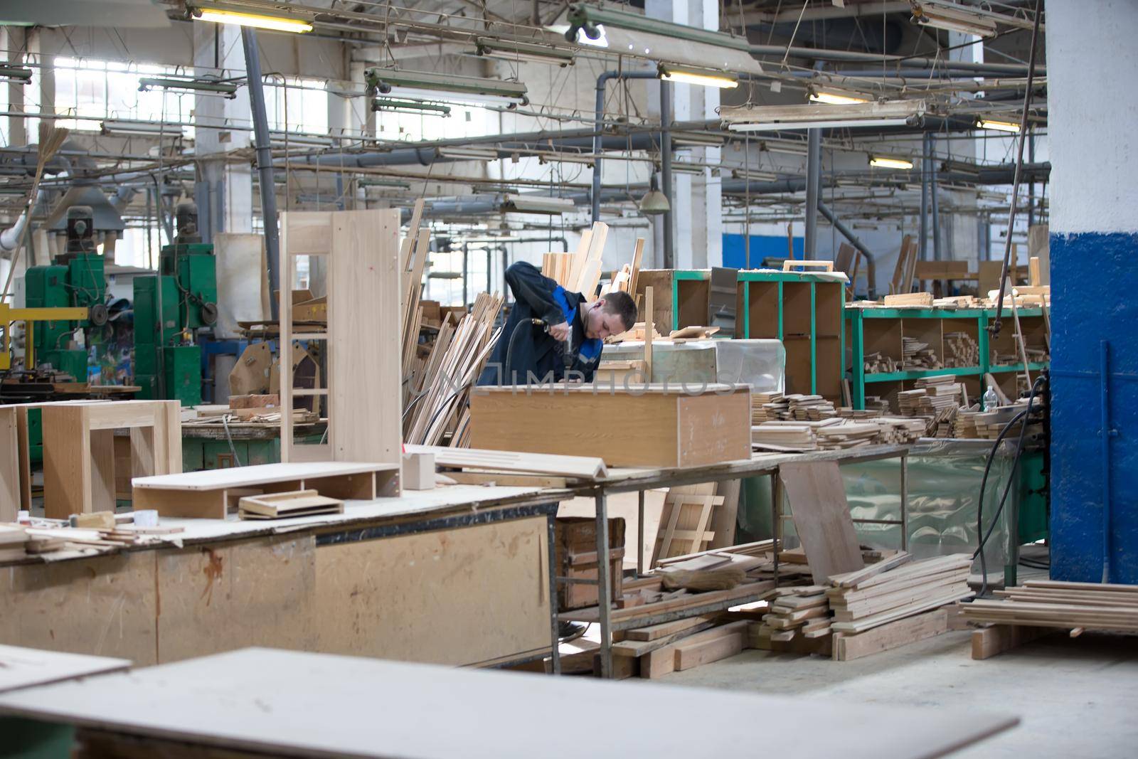 Shop for wood processing and furniture manufacturing. Workers make furniture cabinets