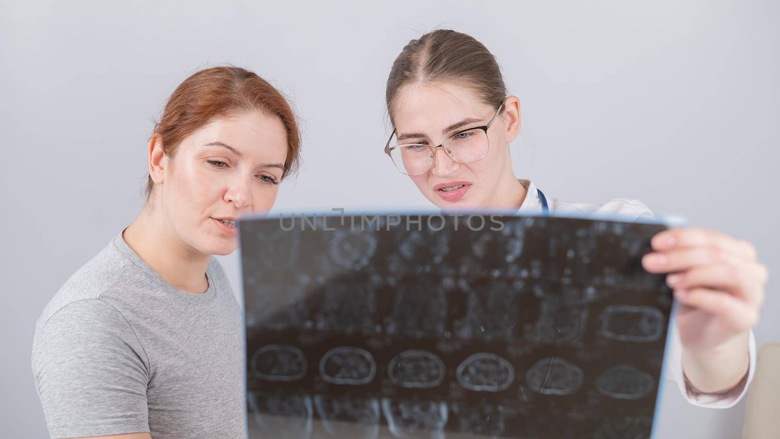 Female doctor explaining mri of internal organs to female patient