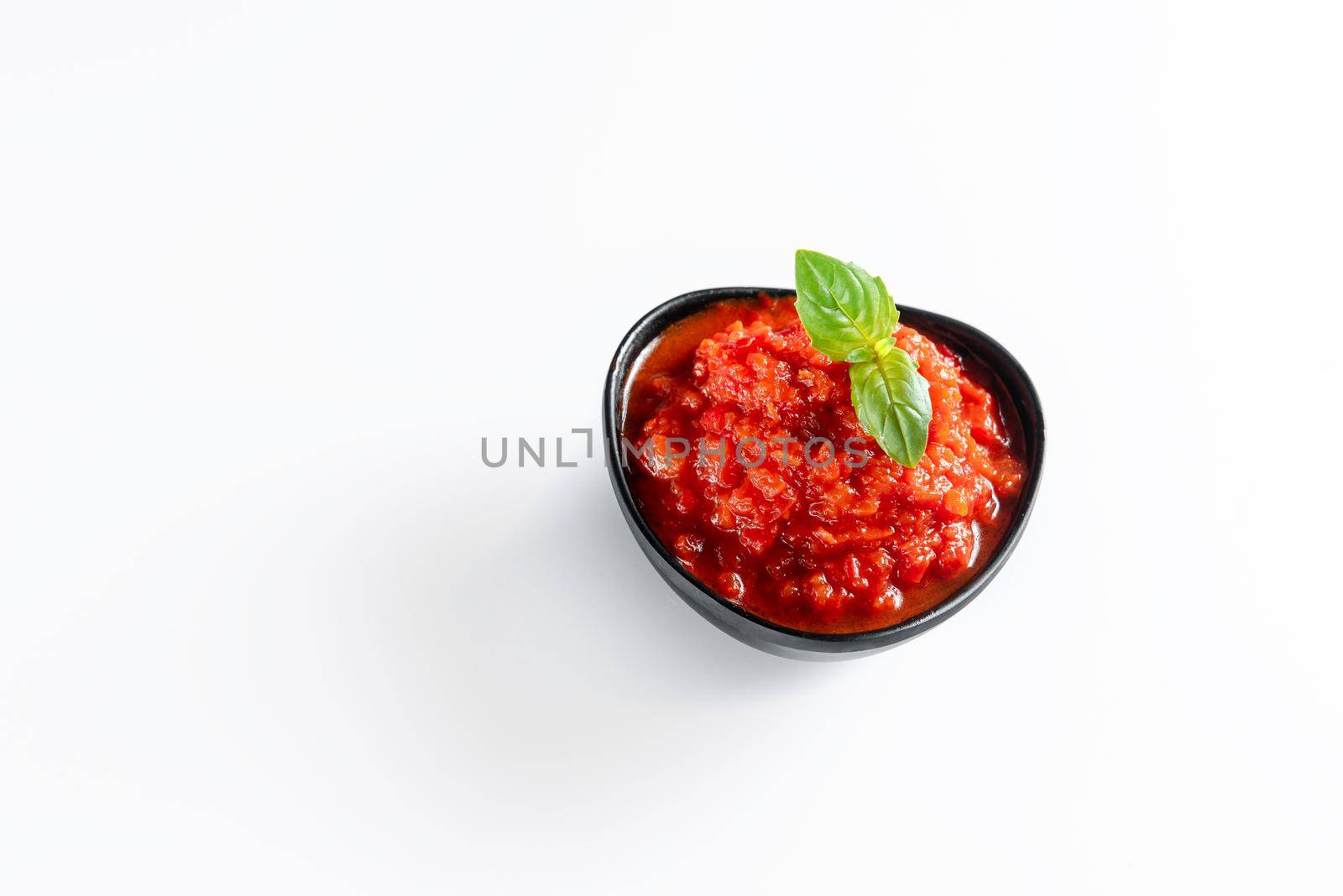 Ajika isolated on a white background. Hot sauce by gulyaevstudio