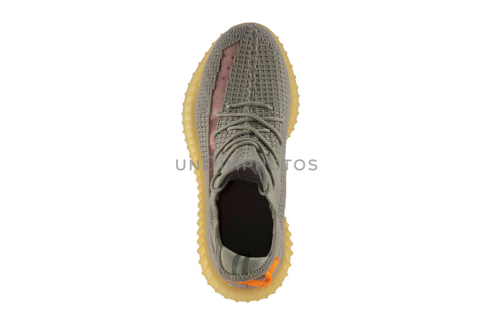 Gray rag sneaker isolated on white background. Cheap sports shoes.