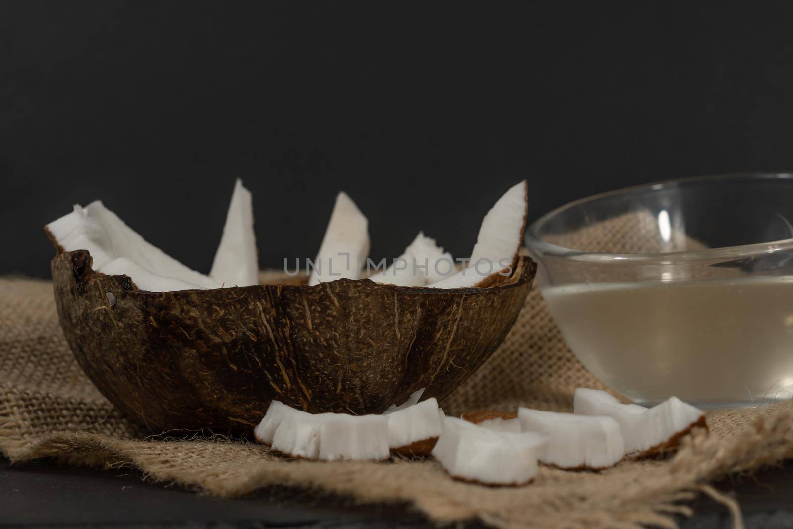 fresh coconut on black background by joseantona