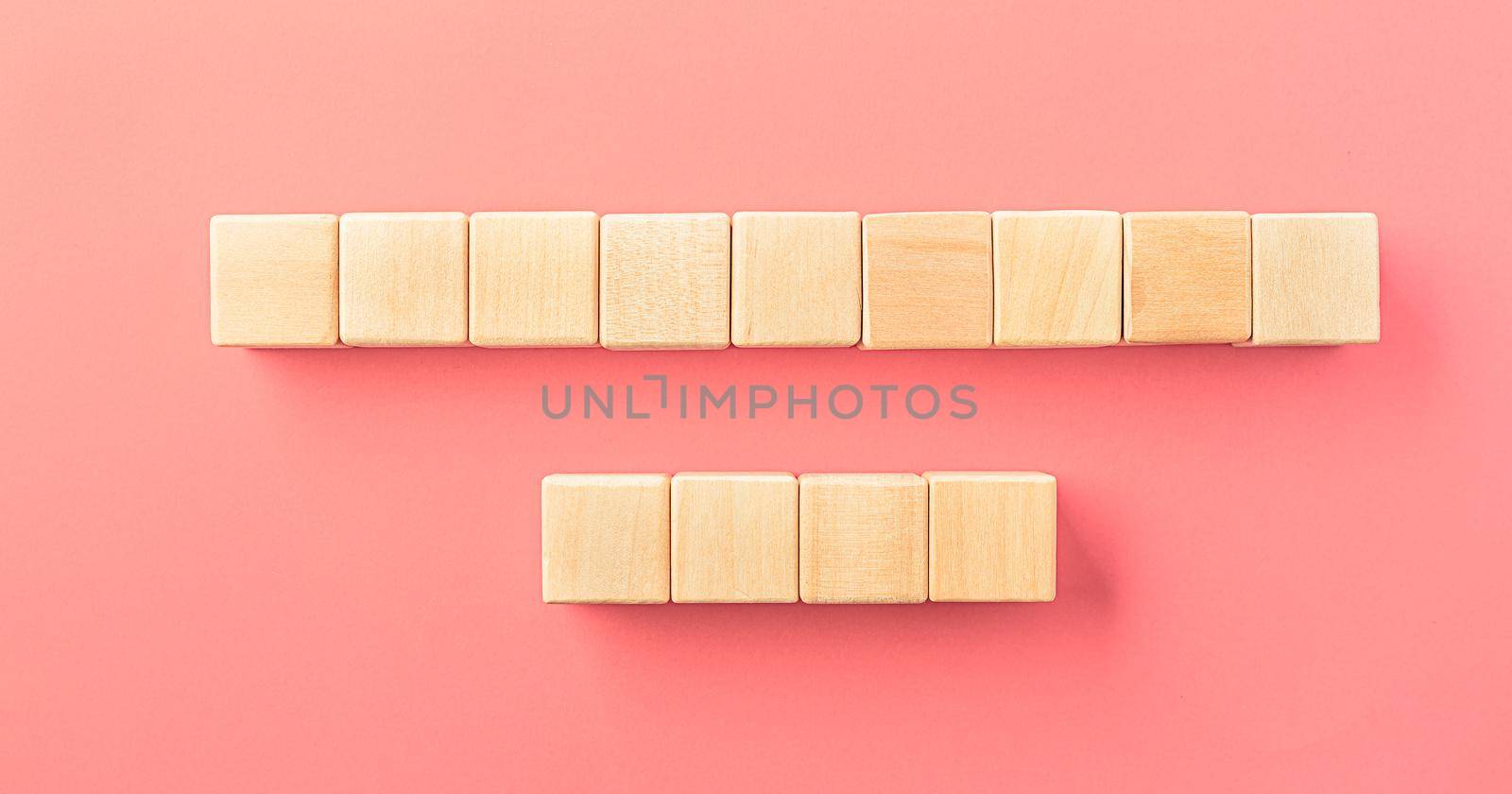 Wooden toy blocks on soft pink background by Ciorba