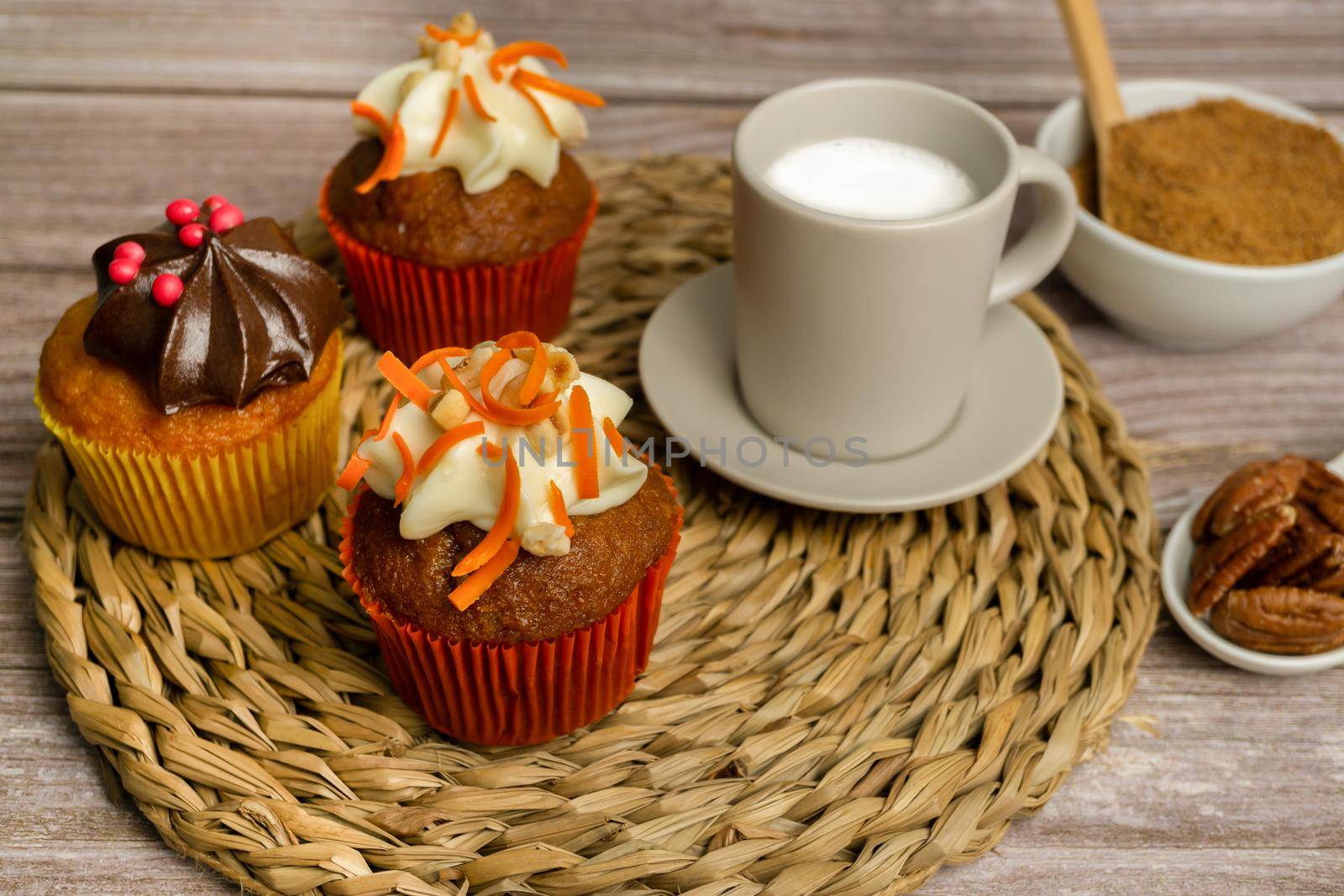 assortment of chocolate and cream and carrot cupcakes on various backgrounds