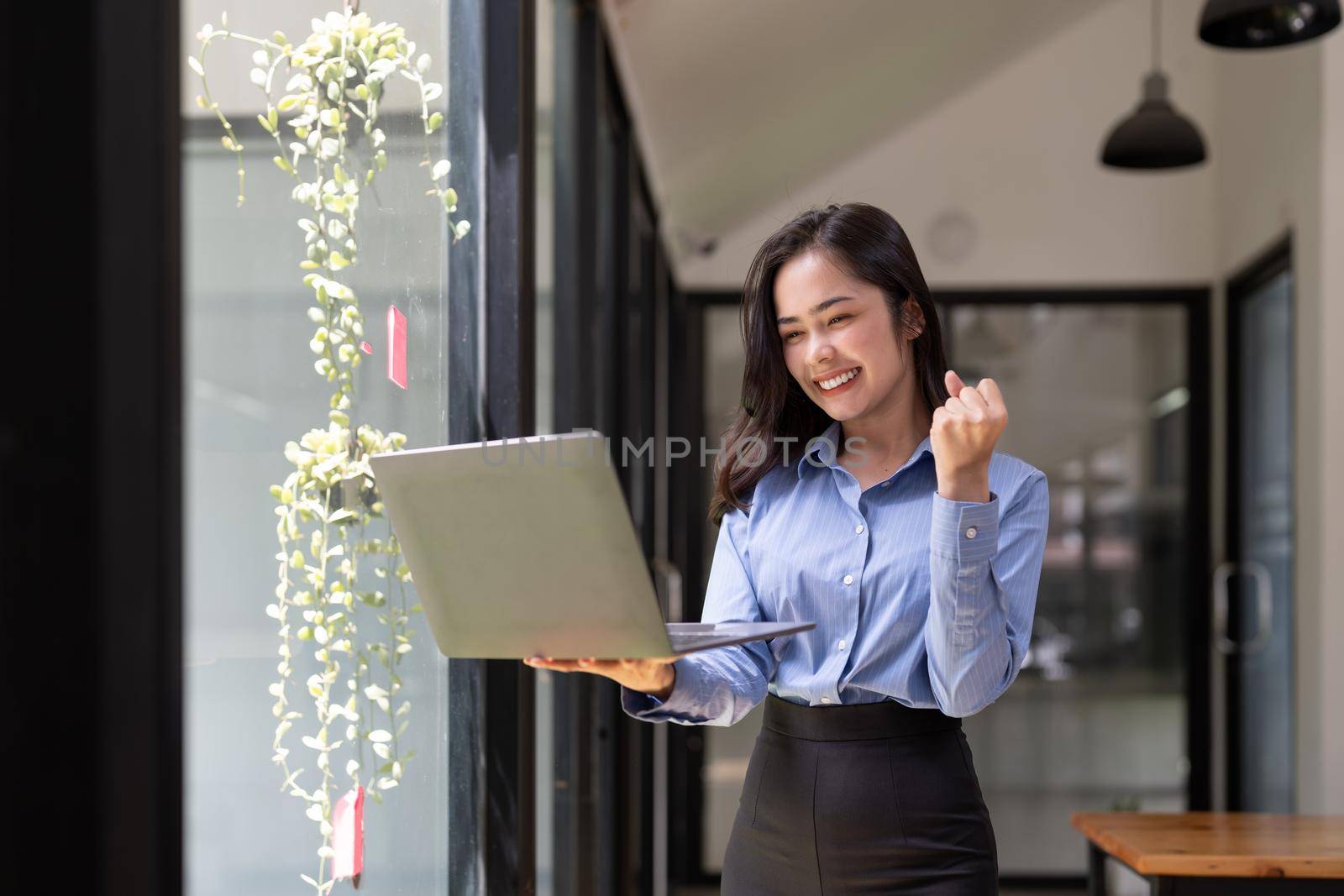 Beautiful asian young woman excited and glad of success with laptop computer, career freelance business concept