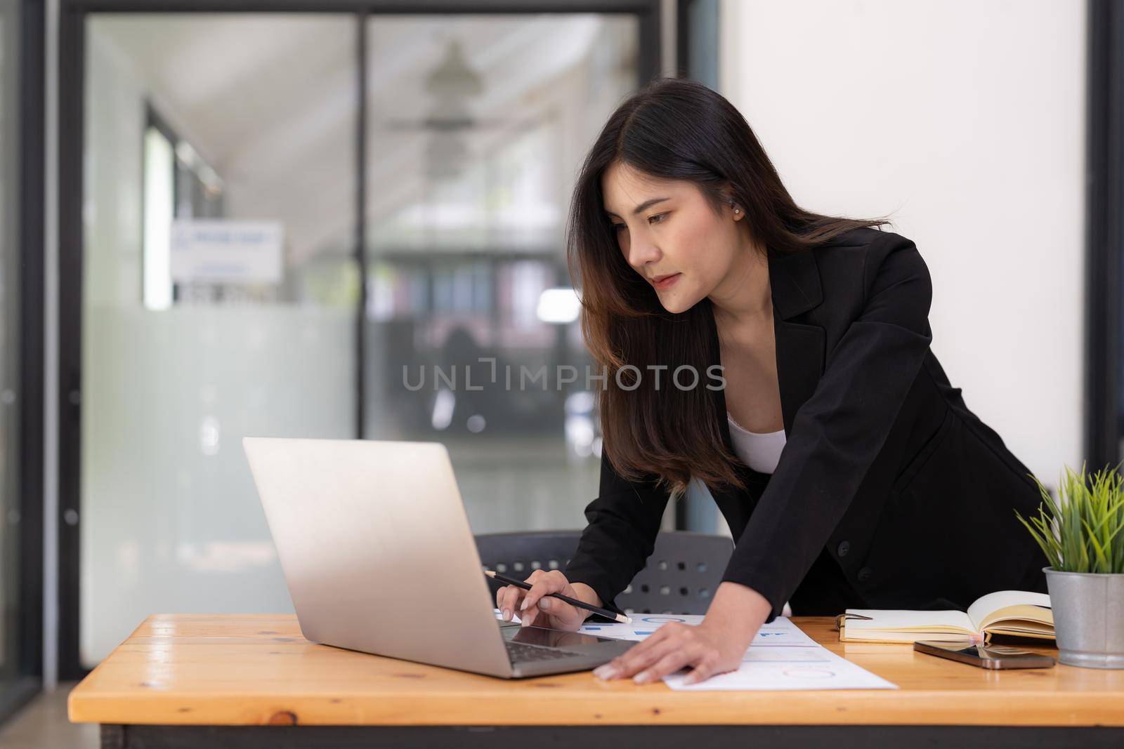 Business woman using calculator for do math finance on wooden desk in office and business working background, tax, accounting, statistics and analytic research concept.