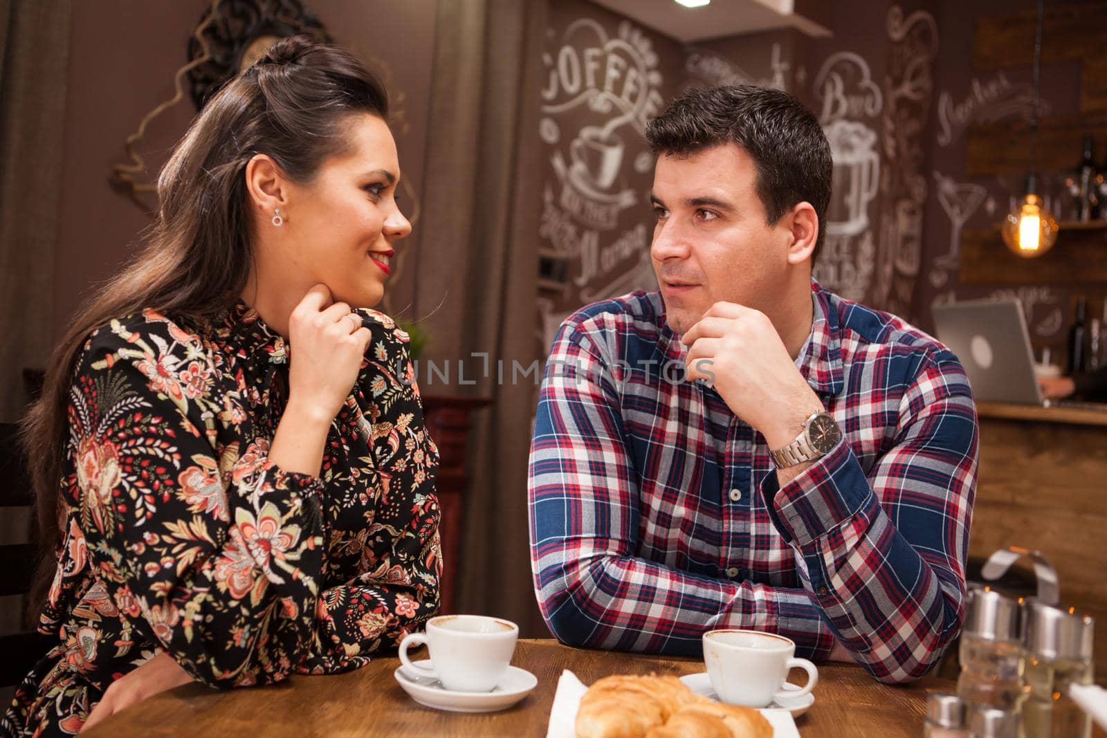 Beautiful inlove couple on a date in vintage pub by DCStudio