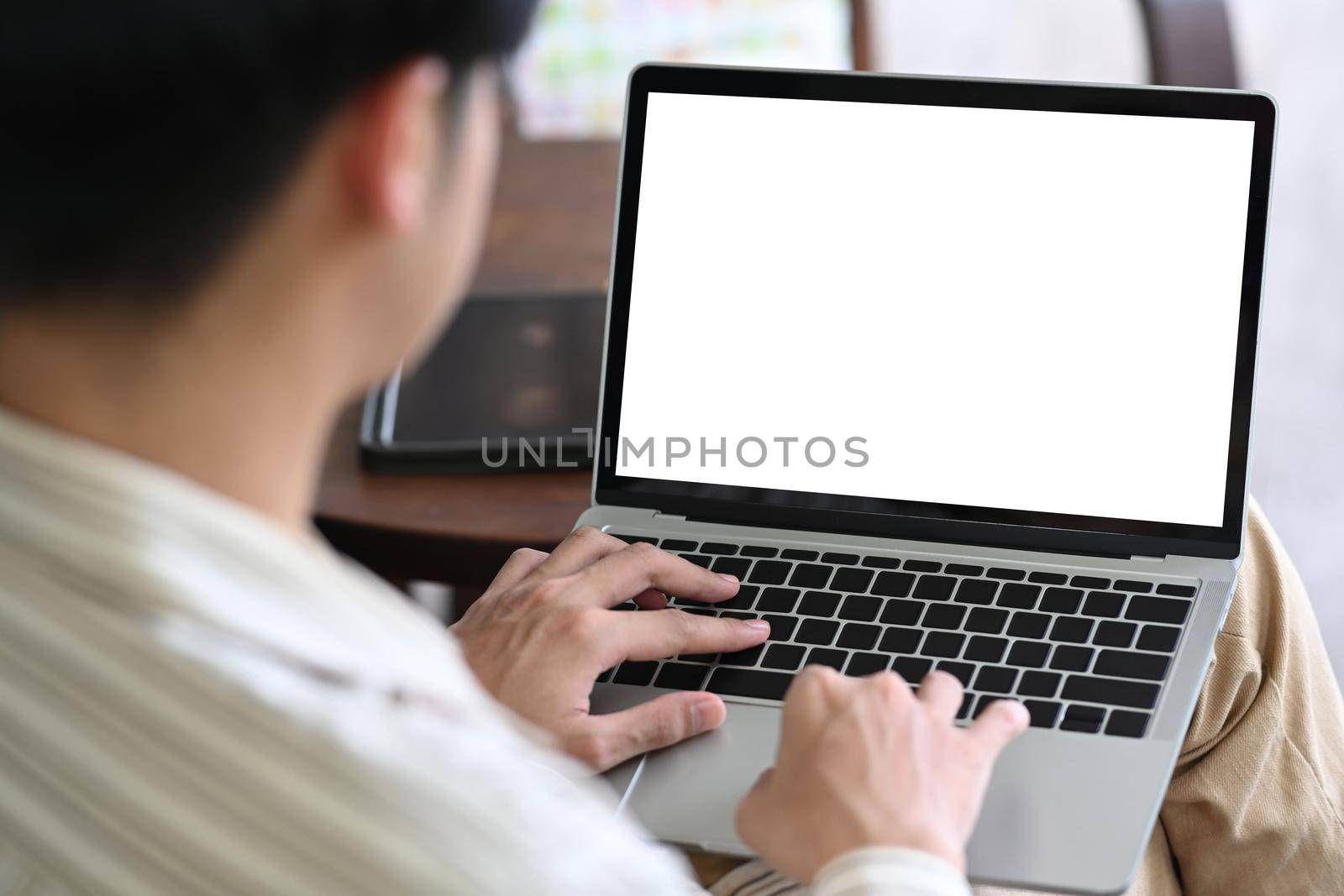 Back view of businessman using laptop computer.