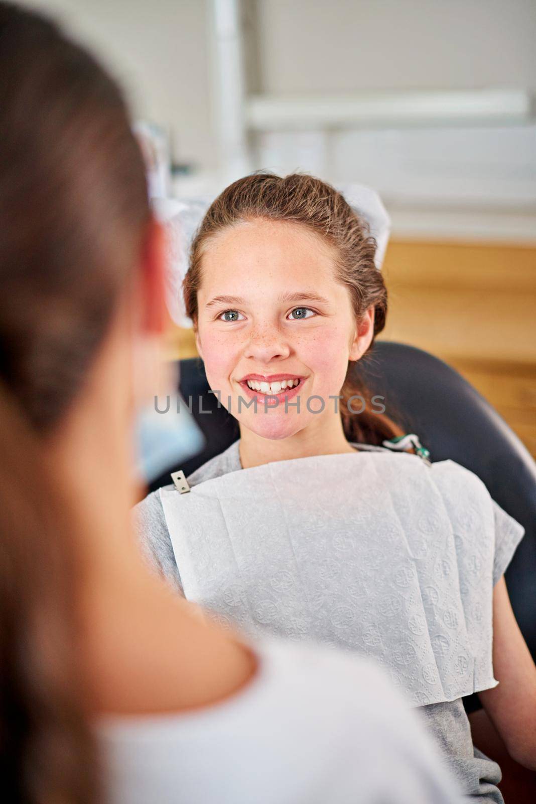 At ease in the dentists chair. a young girl at the dentist. by YuriArcurs