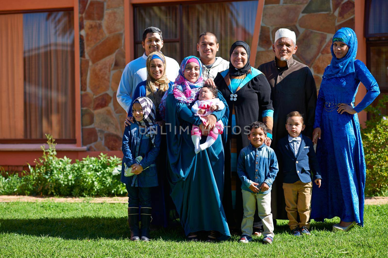 Family first. Portrait of a happy muslim family standing together in front of their house