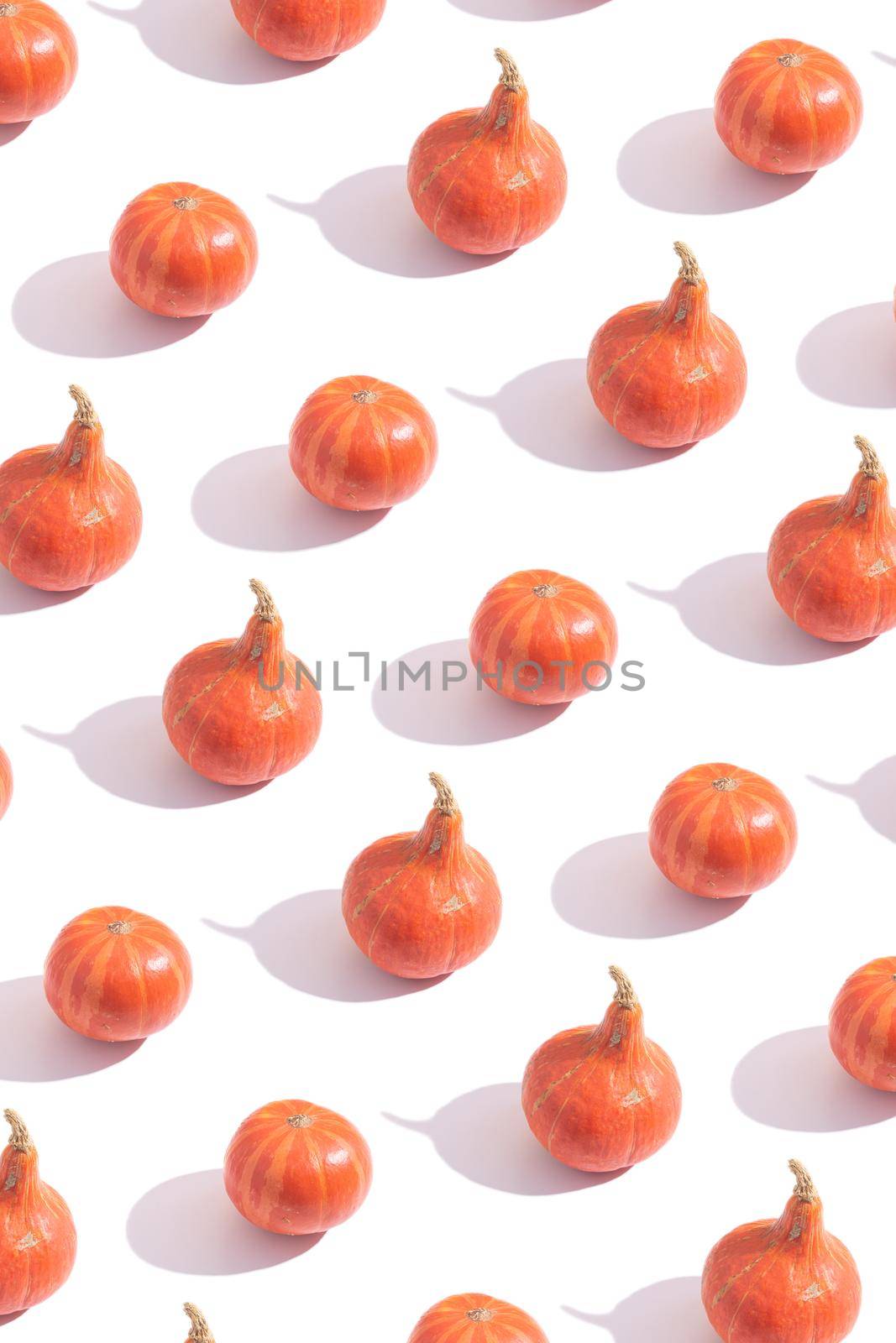 Pattern made from orange pumpkins. Creative autumn vertical background by ssvimaliss