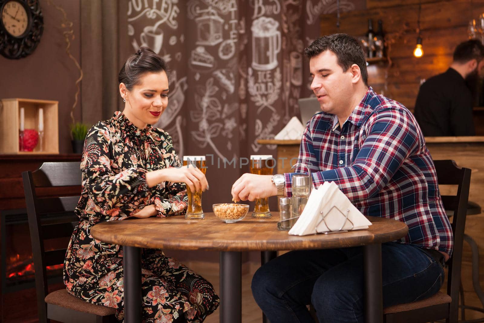 Couple in love on date drinking beer and having a good time. Beautiful couple.