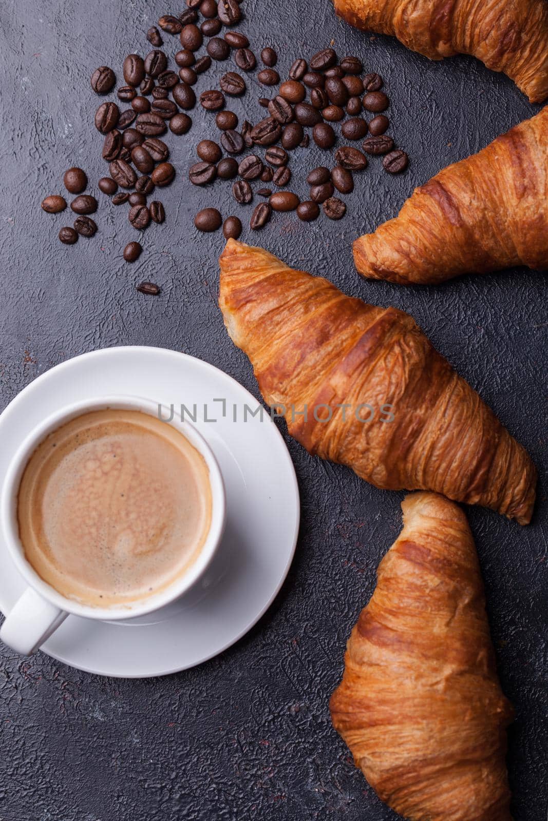 Top view of coffee and croissant with coffee beans. Delicous coffee.