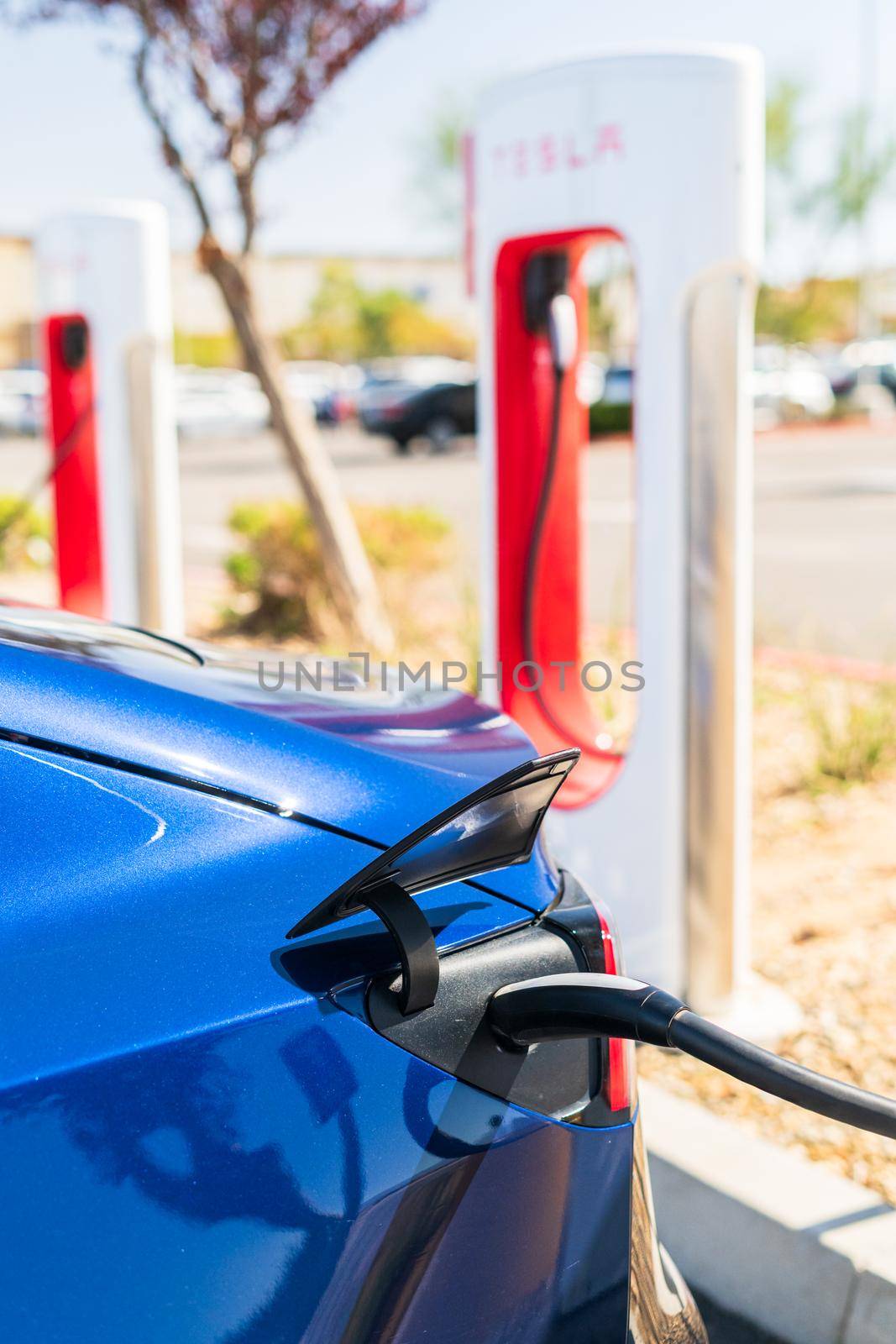 Hesperia, California, USA-October 12, 2021 - Tesla supercharging station during the day.