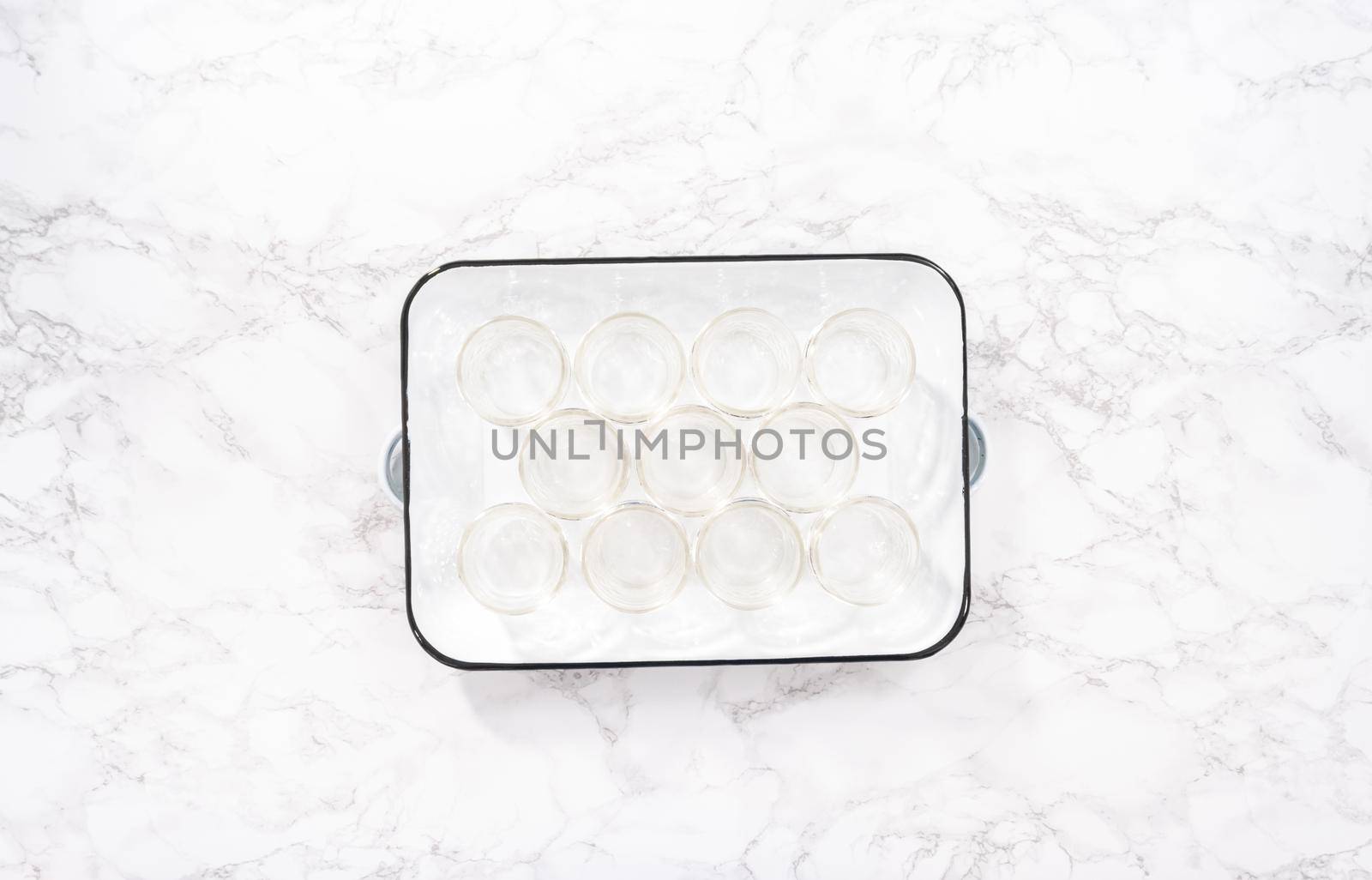 Flat lay. Empty small mason jars on a white metal tray.