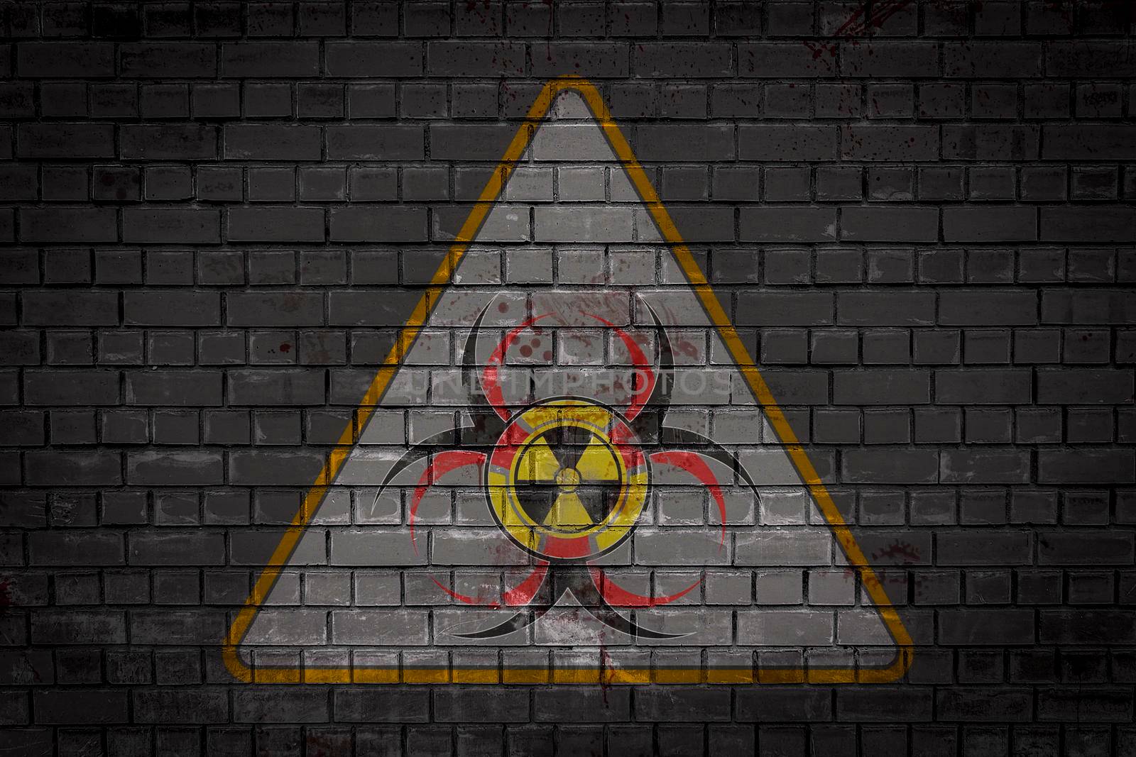 Combined new sign of biological, chemical and nuclear threat depicted in a triangle on a brick wall