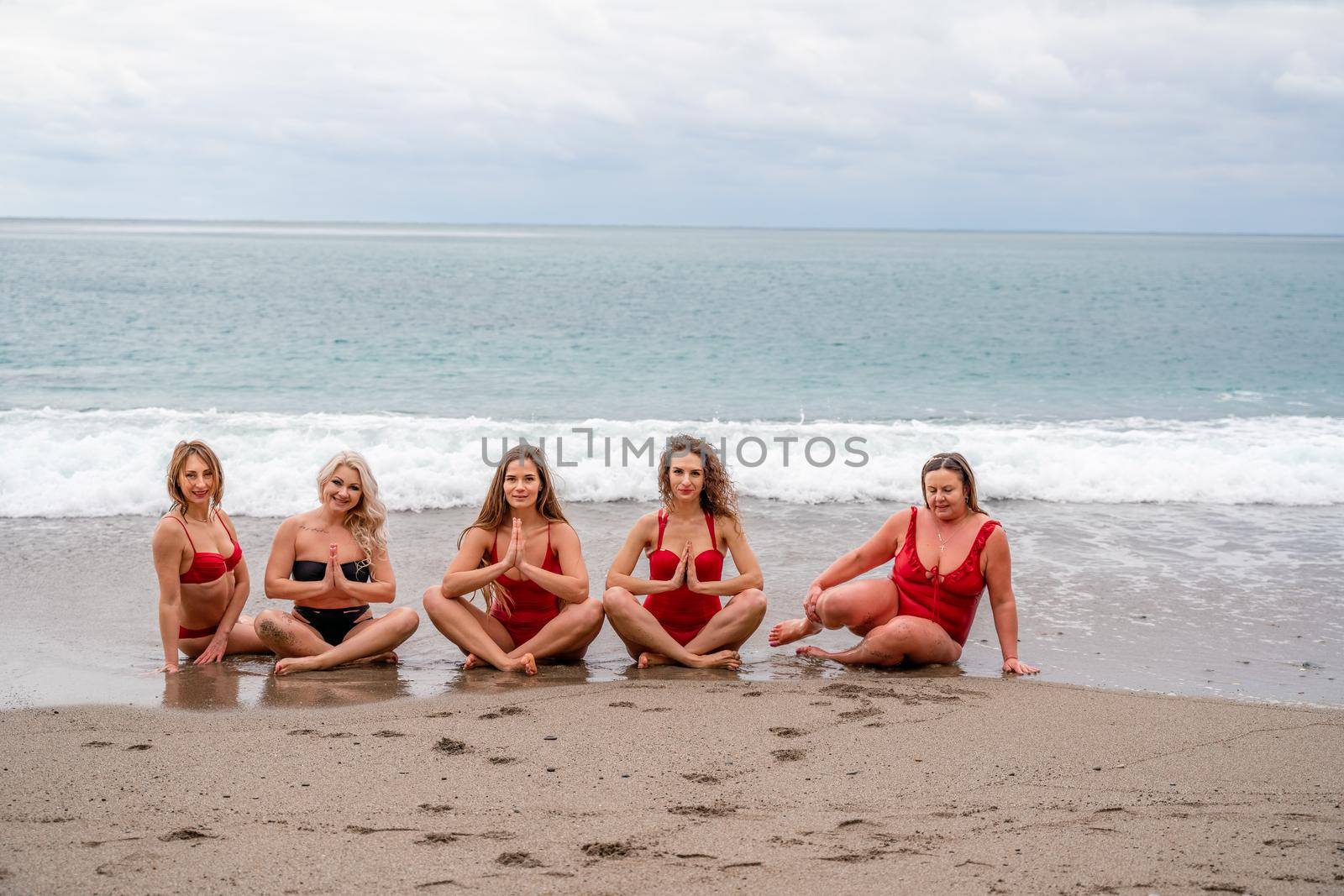 Big happy family or group of five friends is having fun against sunset beach. Beach holidays concept