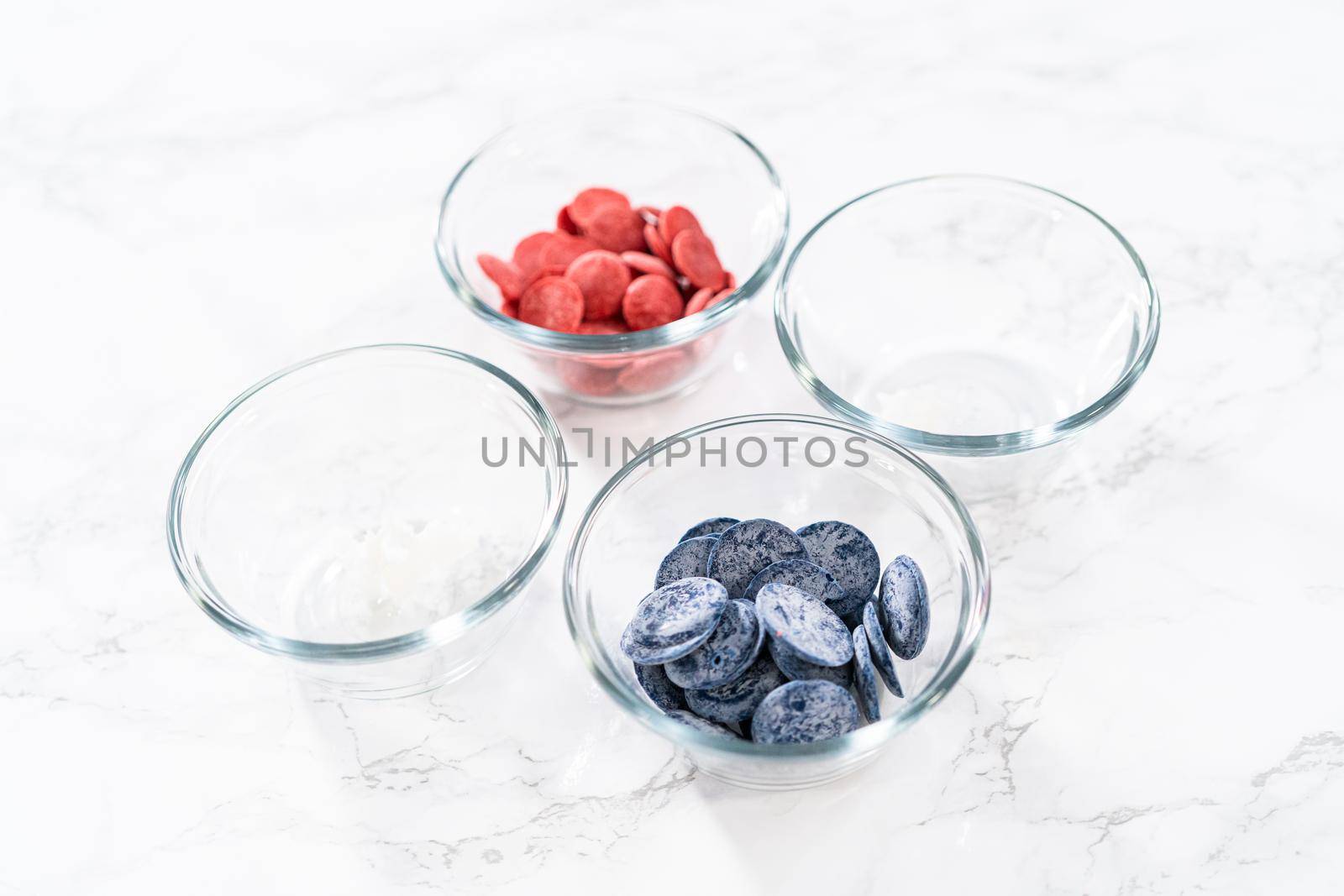 Measured ingredients in glass mixing bowls to make chocolate stars for patriotic lemon cupcakes.