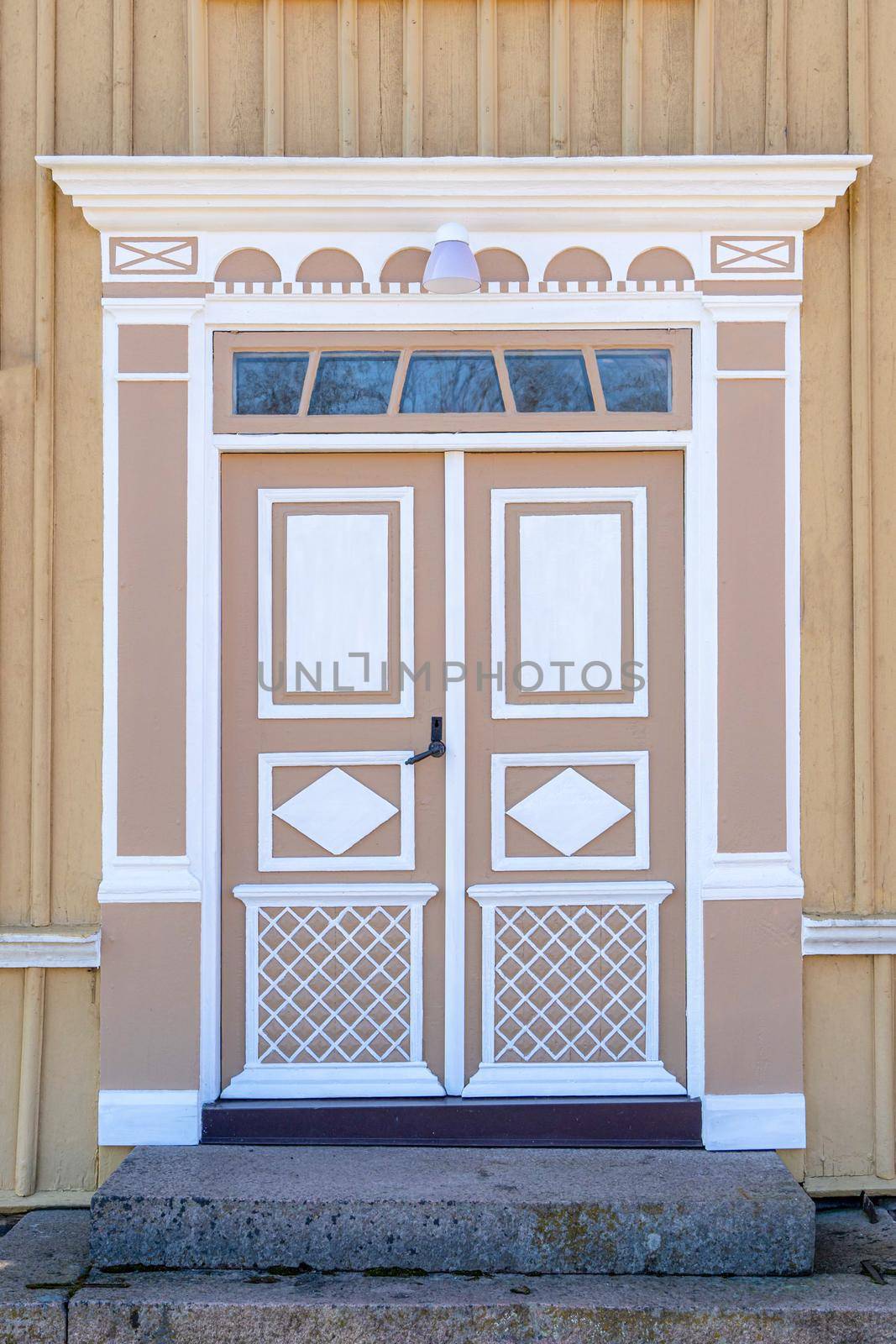 Image of The detail of colorful decorated historic wooden entrance door of old house in Sweden