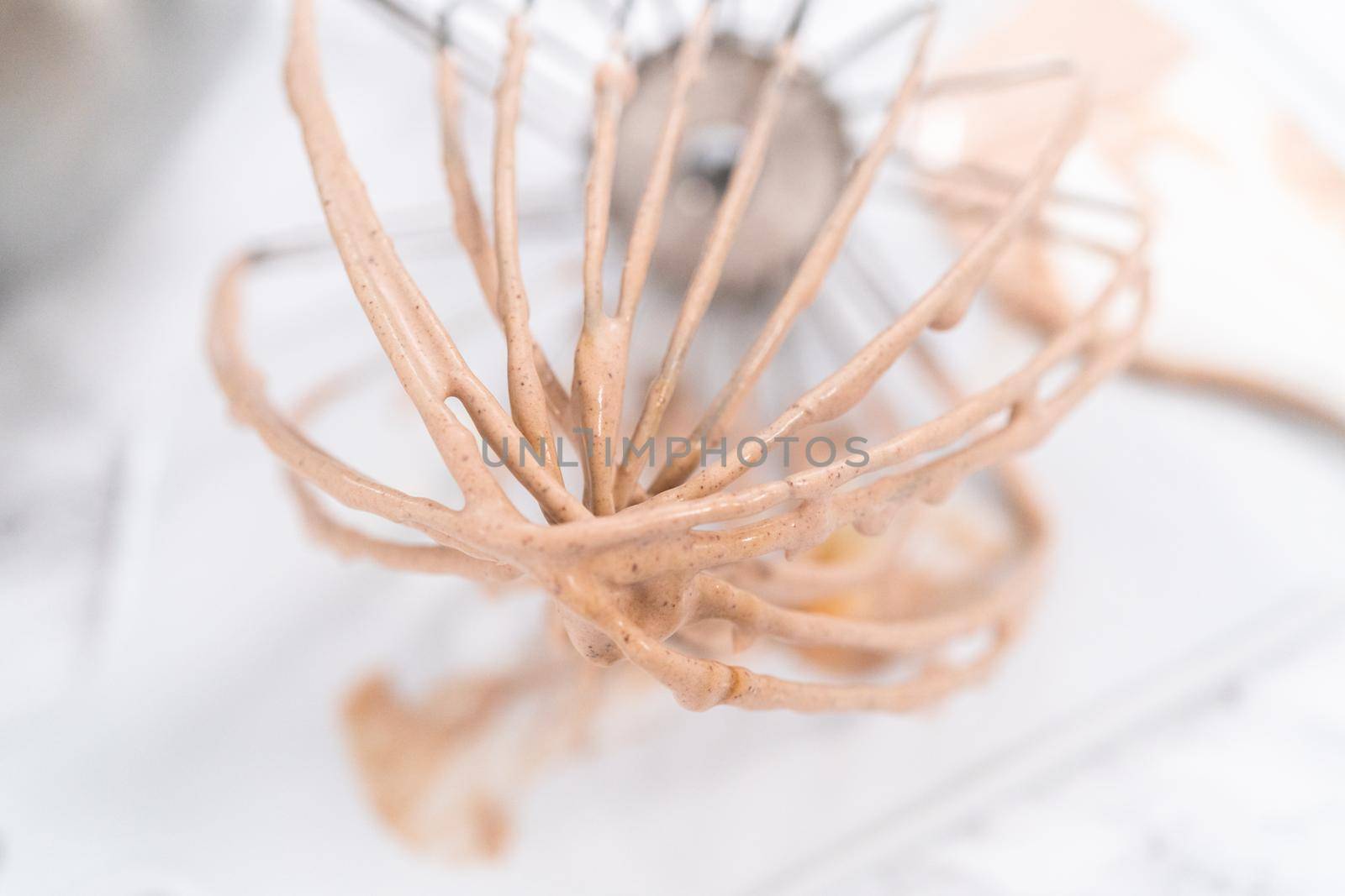 Mixing ingredients in a standing kitchen mixer to make homemade chocolate ice cream.
