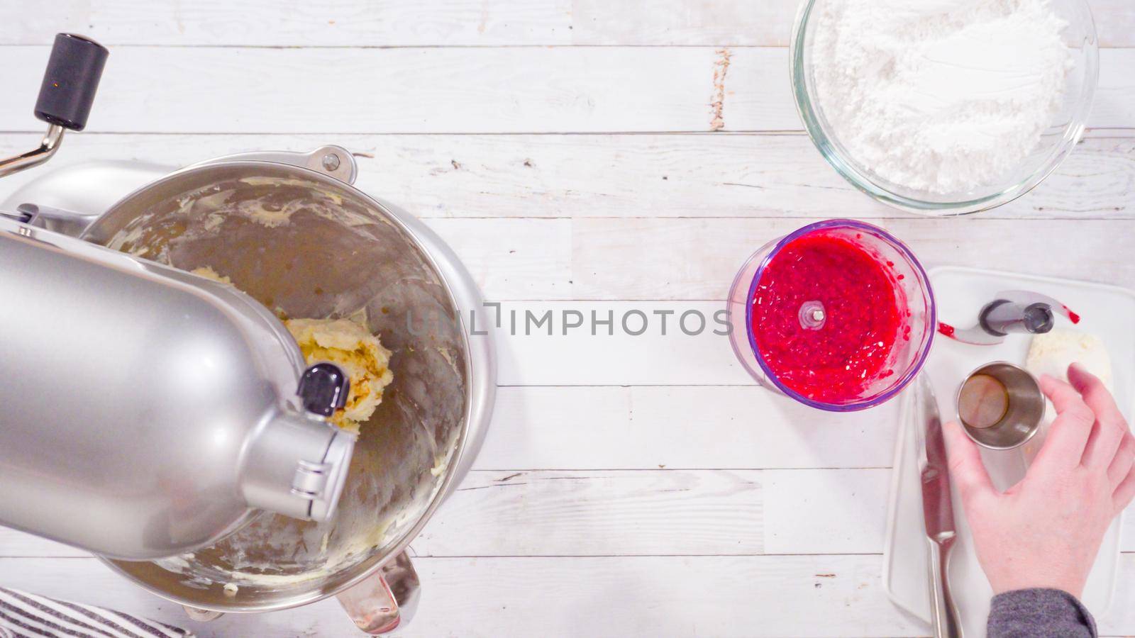 Flat lay. Preparing raspberry cream cheese buttercream in kitchen mixer for bake chocolate raspberry cupcakes.