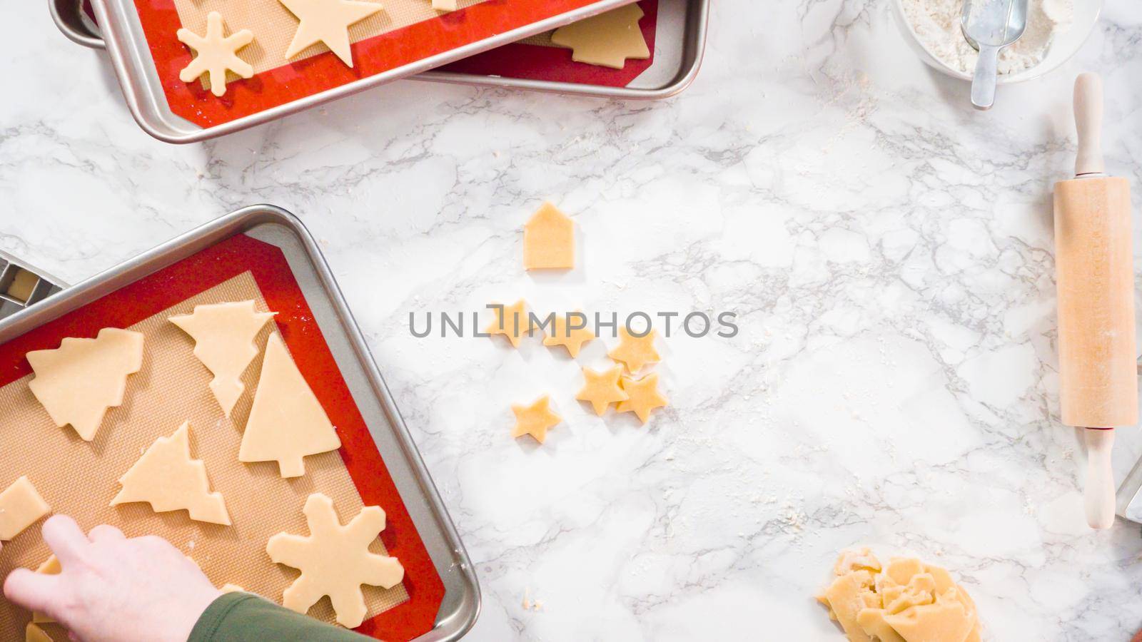 Flat lay. Step by step. Cutting out shapes with Christmas cookies cutter from sugar cookie dough.