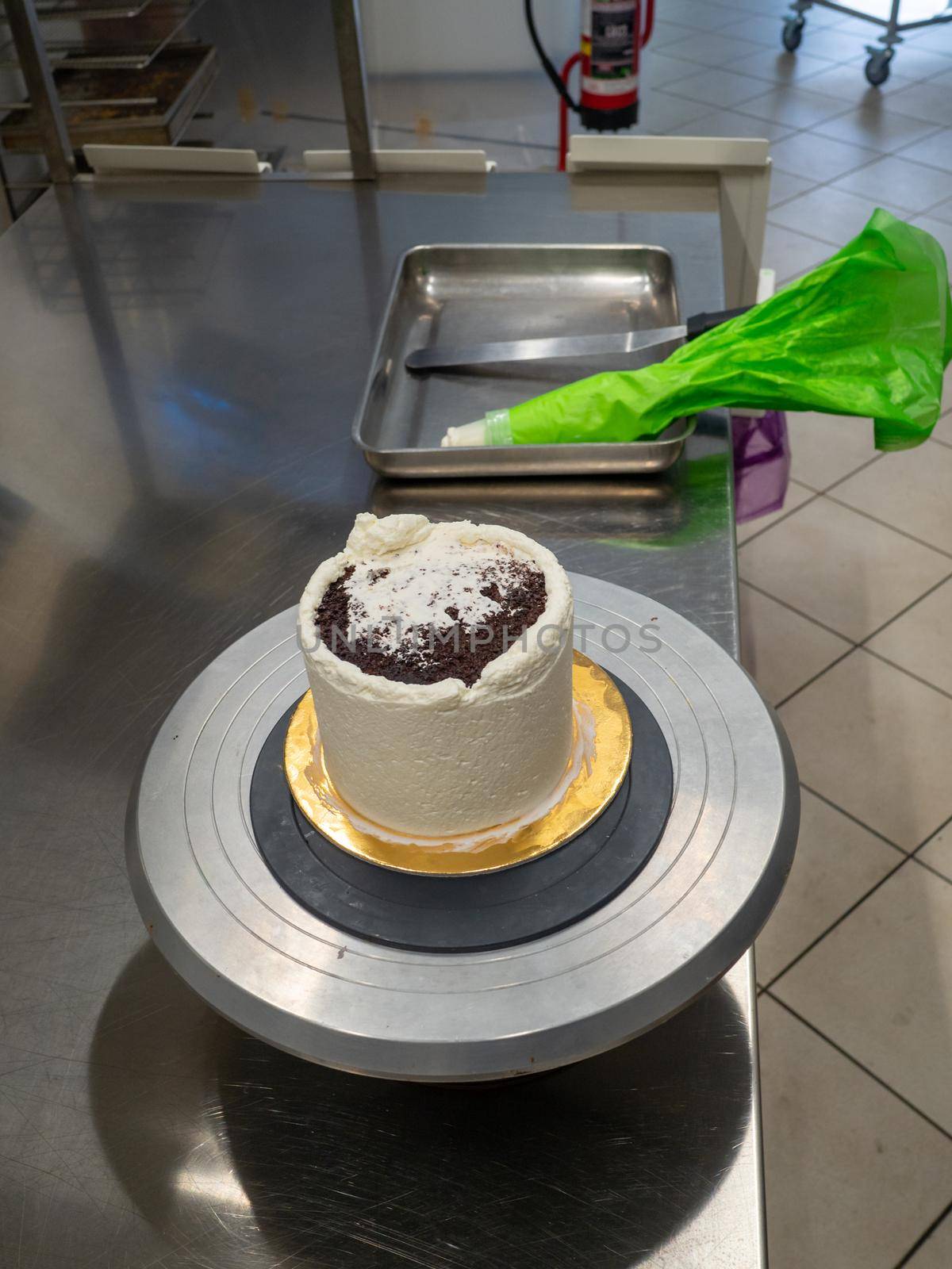 chef at work preparing a drip cake