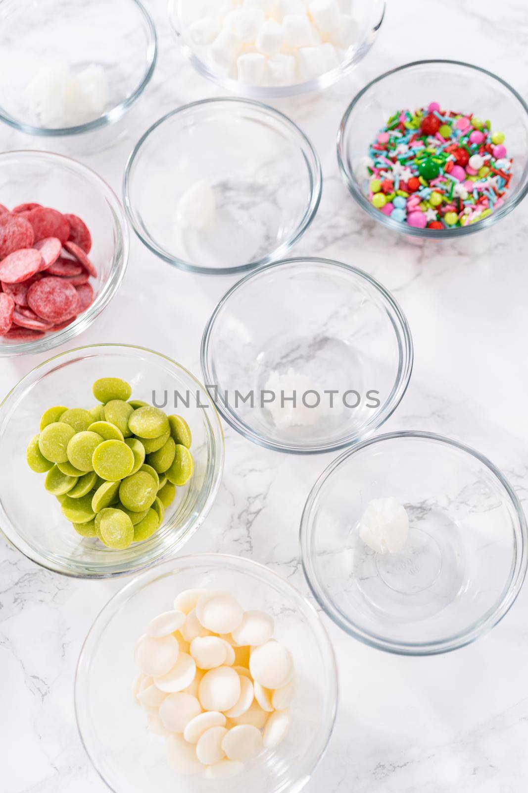 Measured ingredients in a glass mixing bowl to prepare hot chocolate bombs.